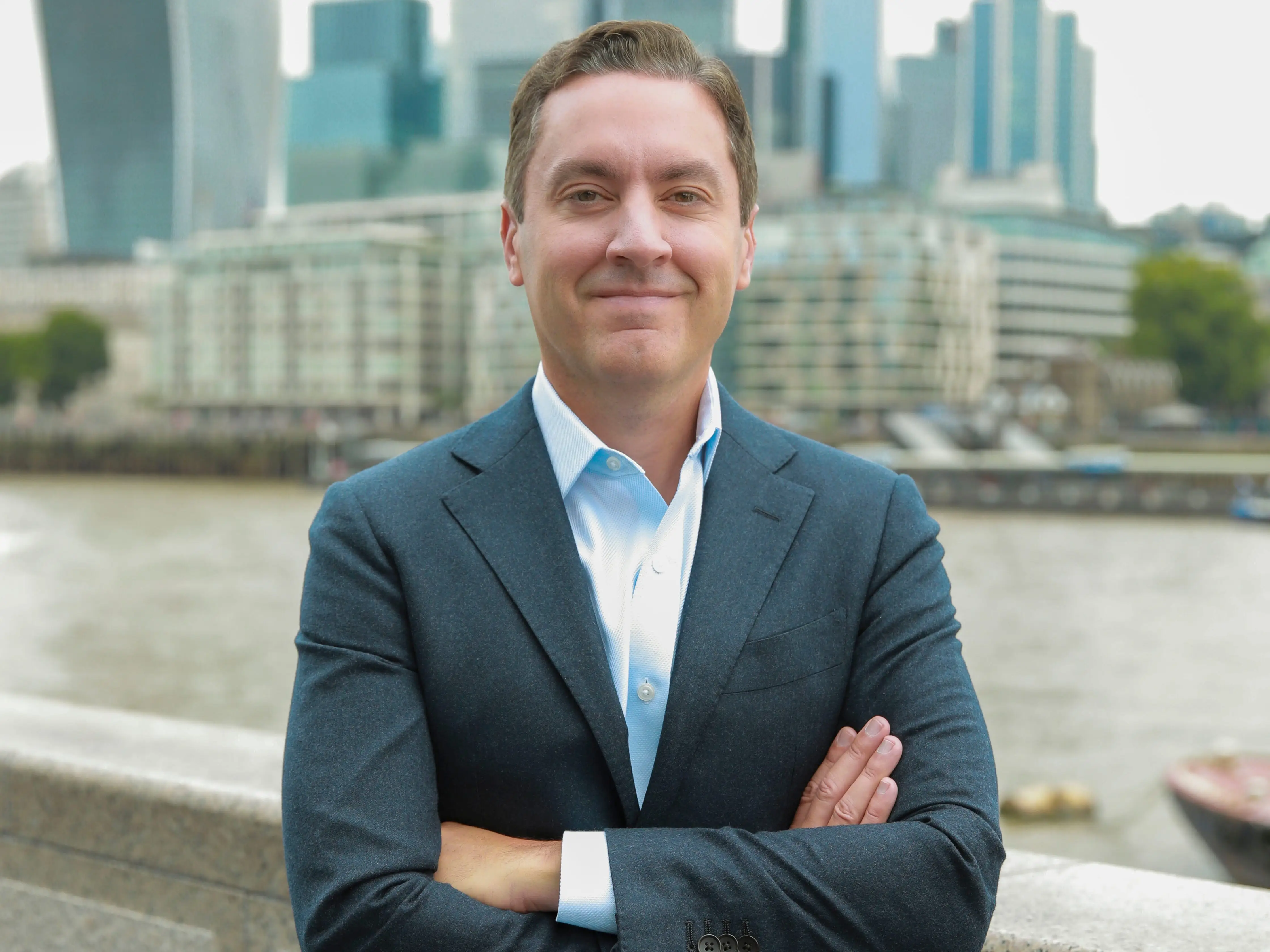 Joe Depa smiling with arms crossed