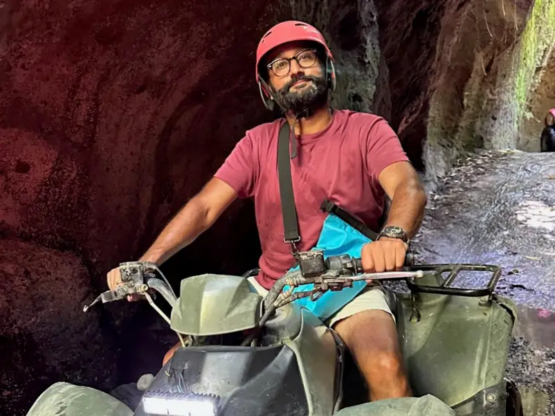 Himal Mandalia wearing a helmet and driving a quad bike.