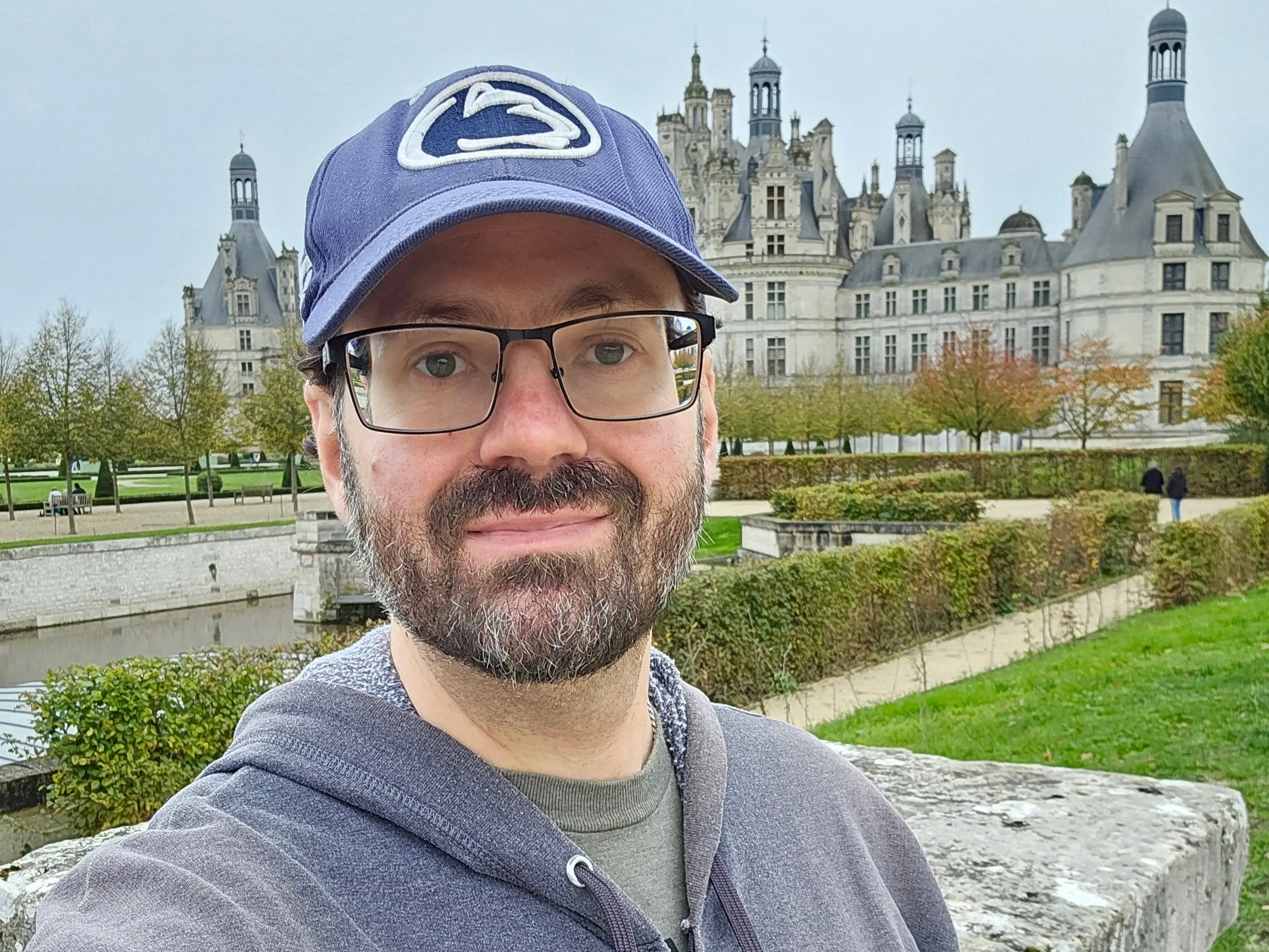 Man in hat with glasses taking selfie