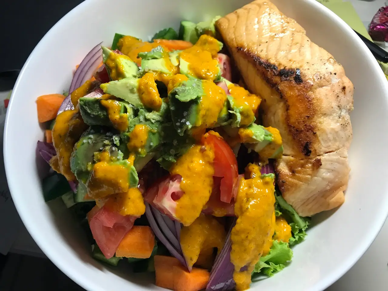 Salmon with veggies with orange dressing on top