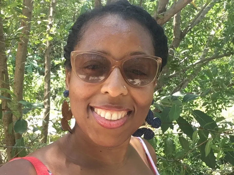 Author Halona Black smiling outside with sunglasses