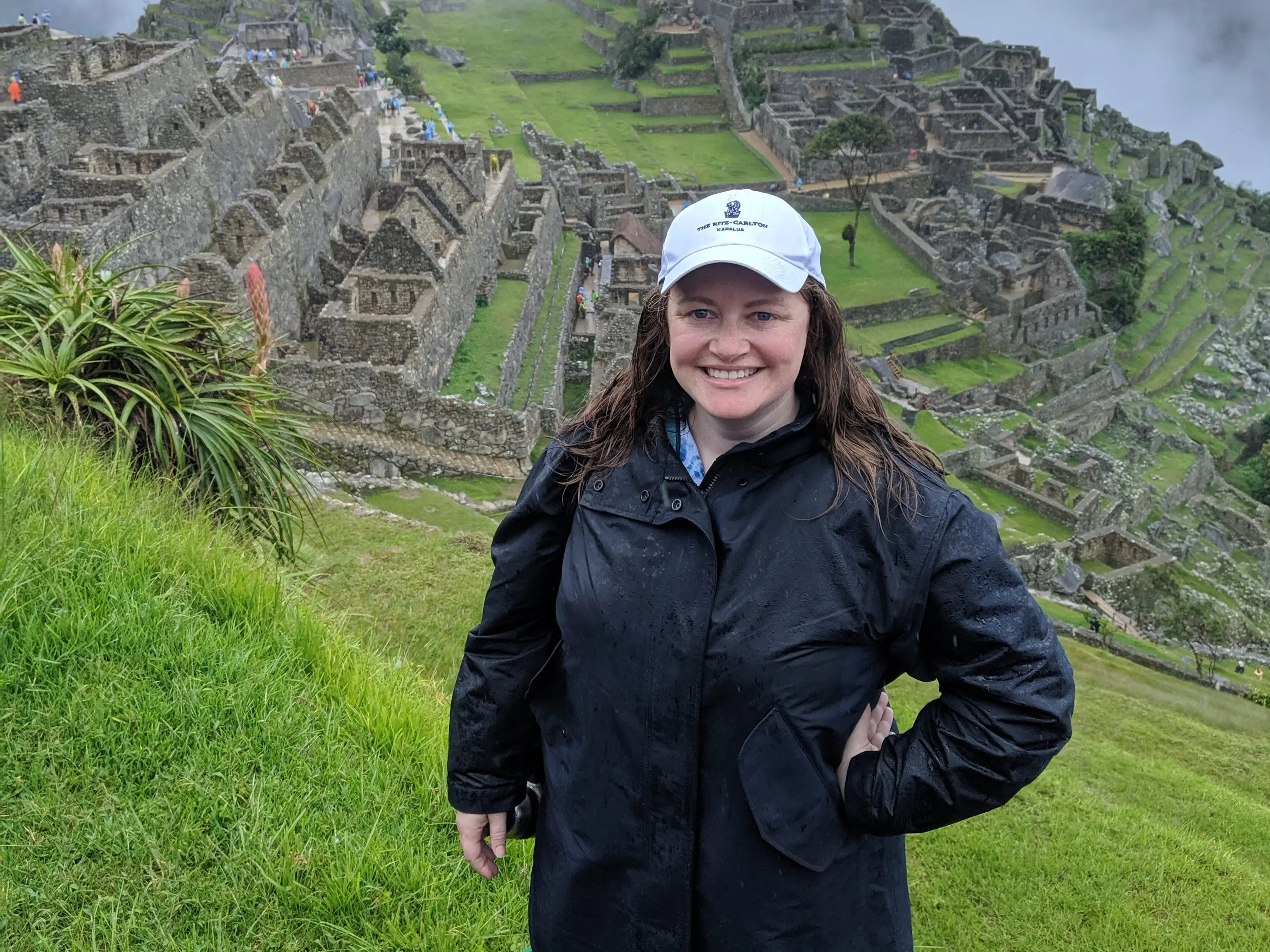 Woman smiling in front of stone relics