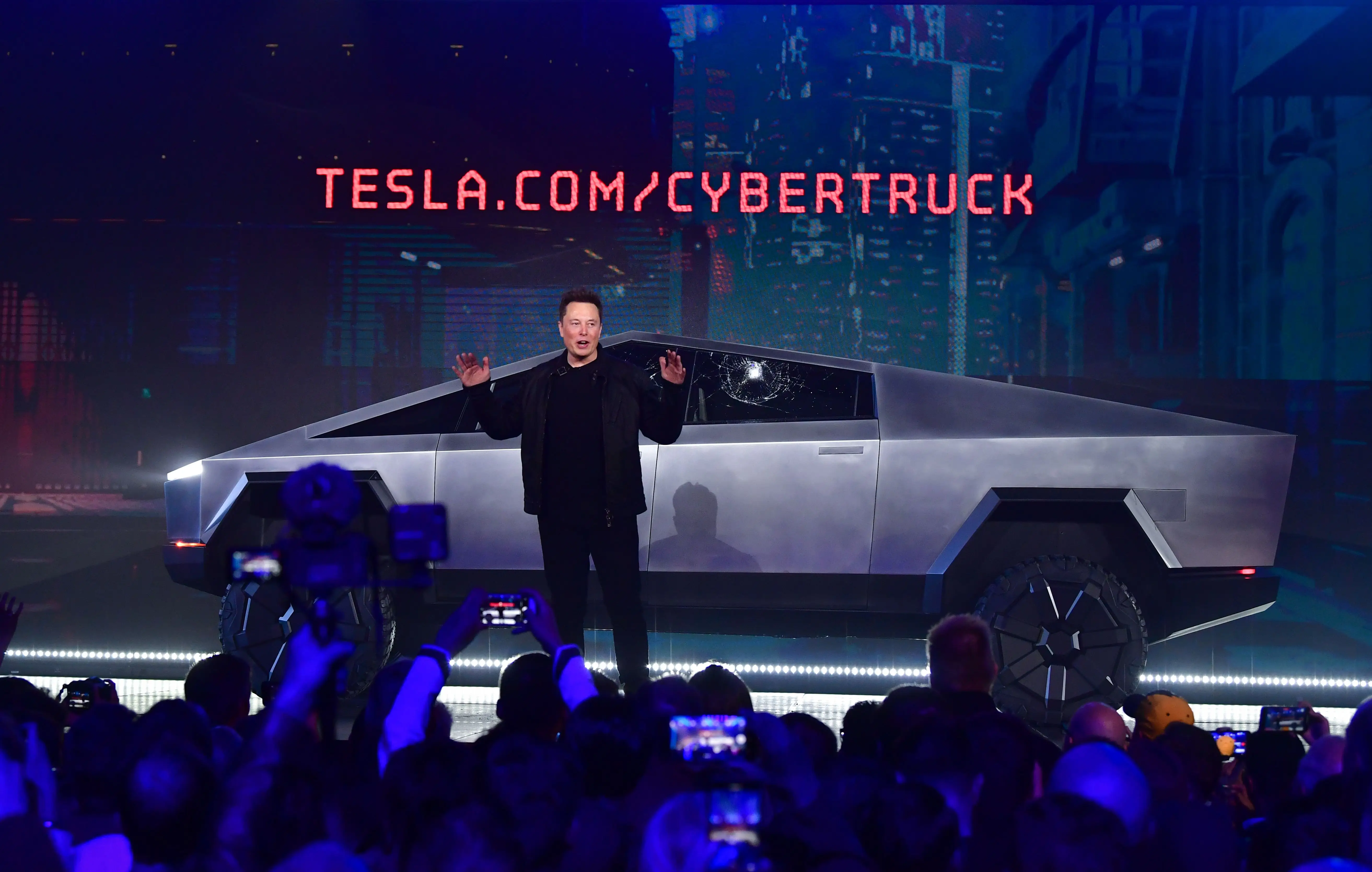 Elon Musk is pictured with a Cybertruck.