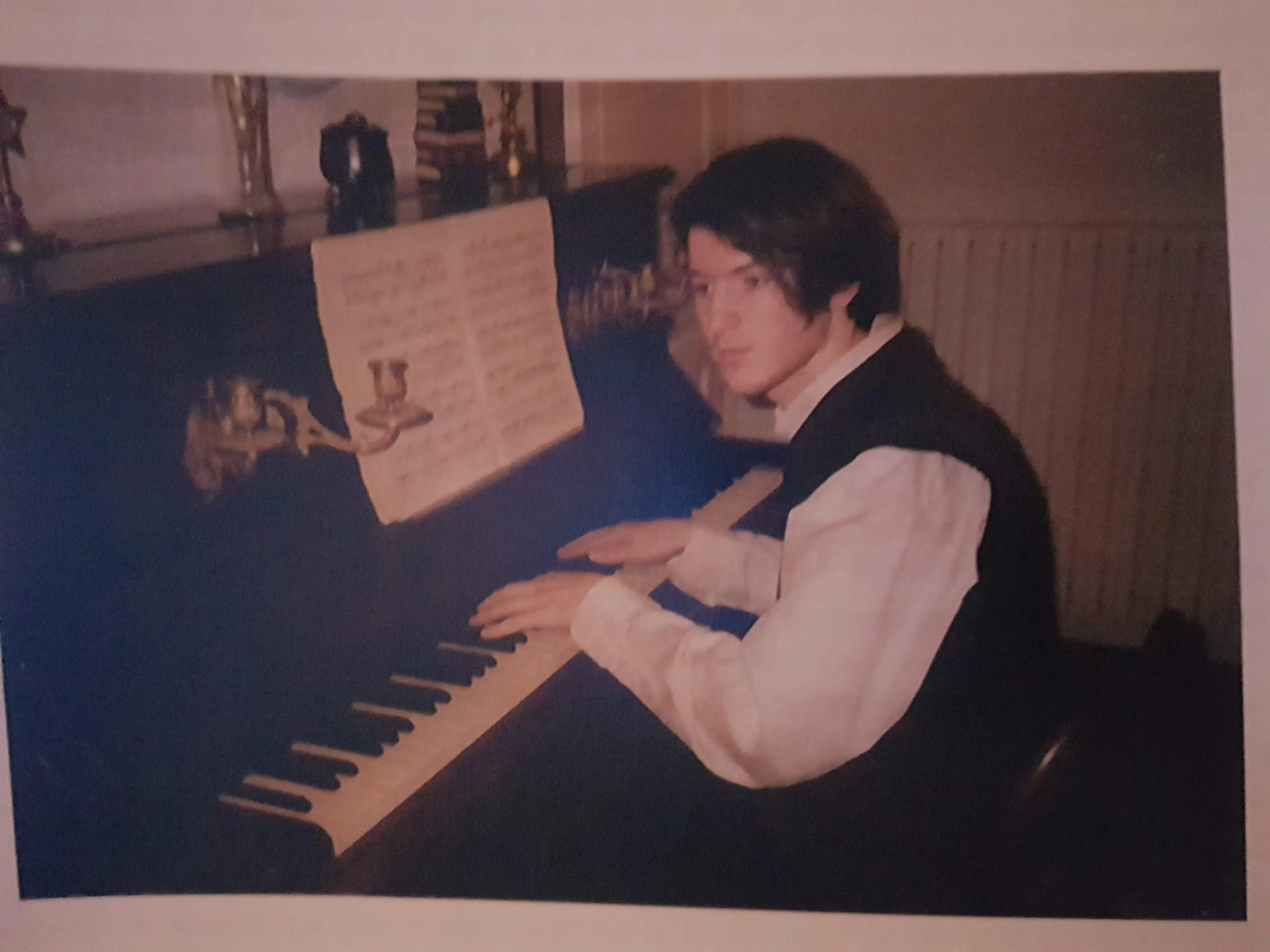 A young man playing the piano