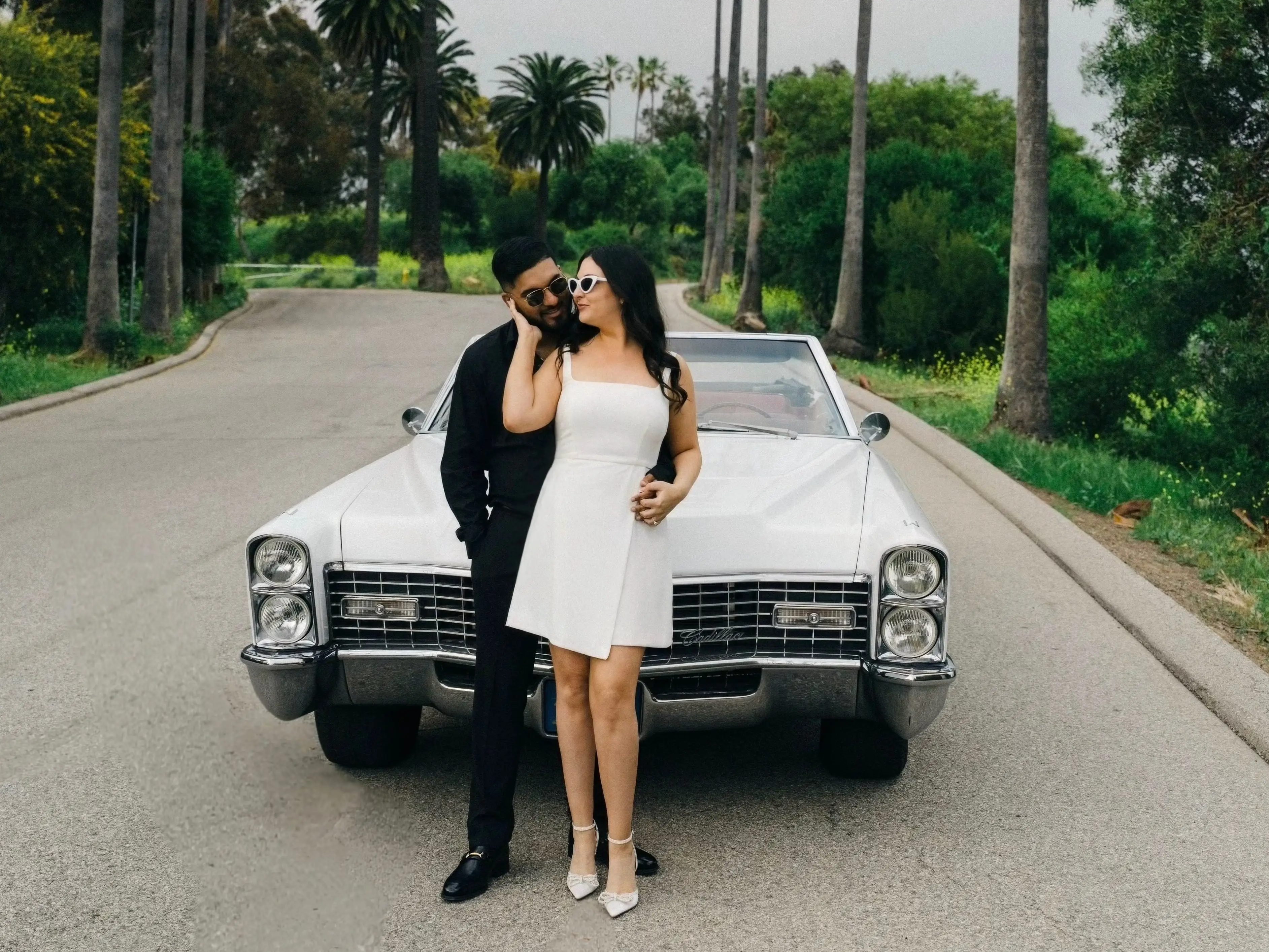 Marissa Chiechi and her husband, Rejoy, stand near a car on a Los Angeles Road.