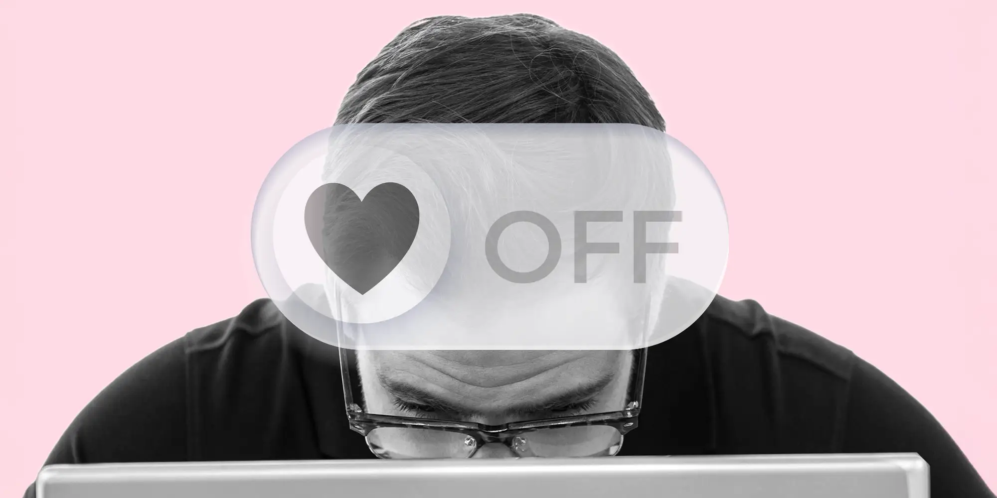 A tech worker, focused on a laptop, with a 