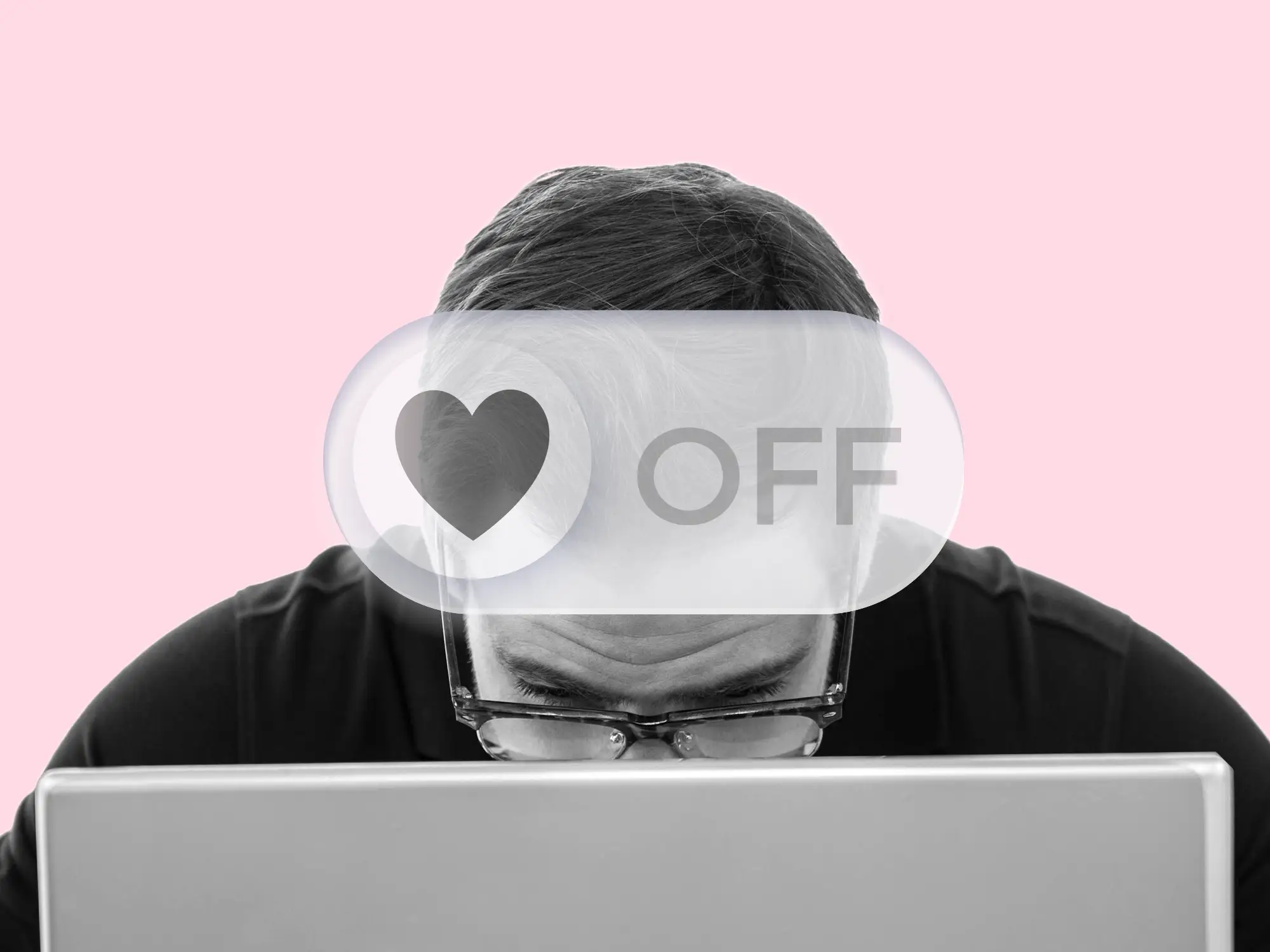 A tech worker, focused on a laptop, with a 