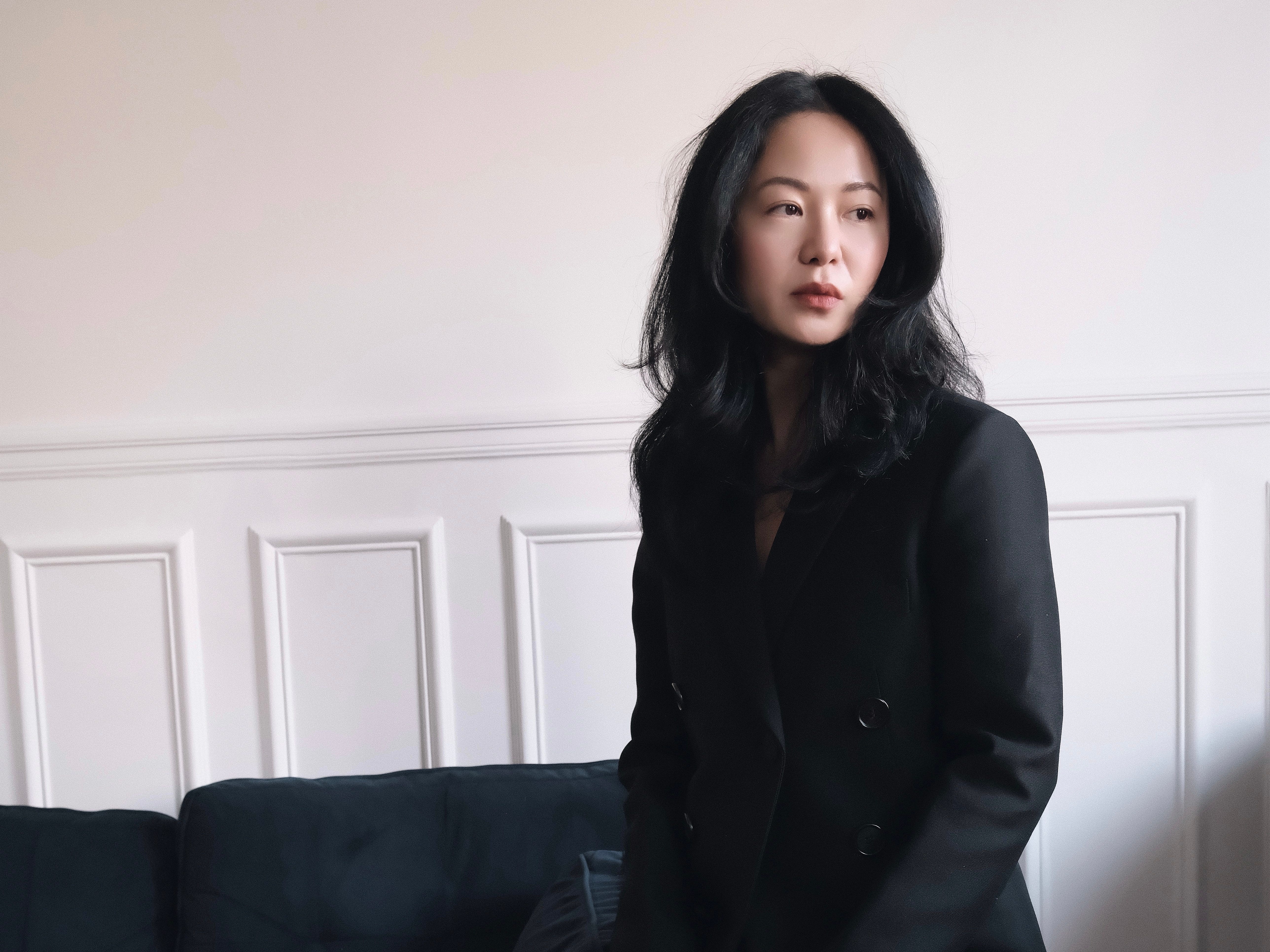 Shiyao Tang sitting on edge of couch