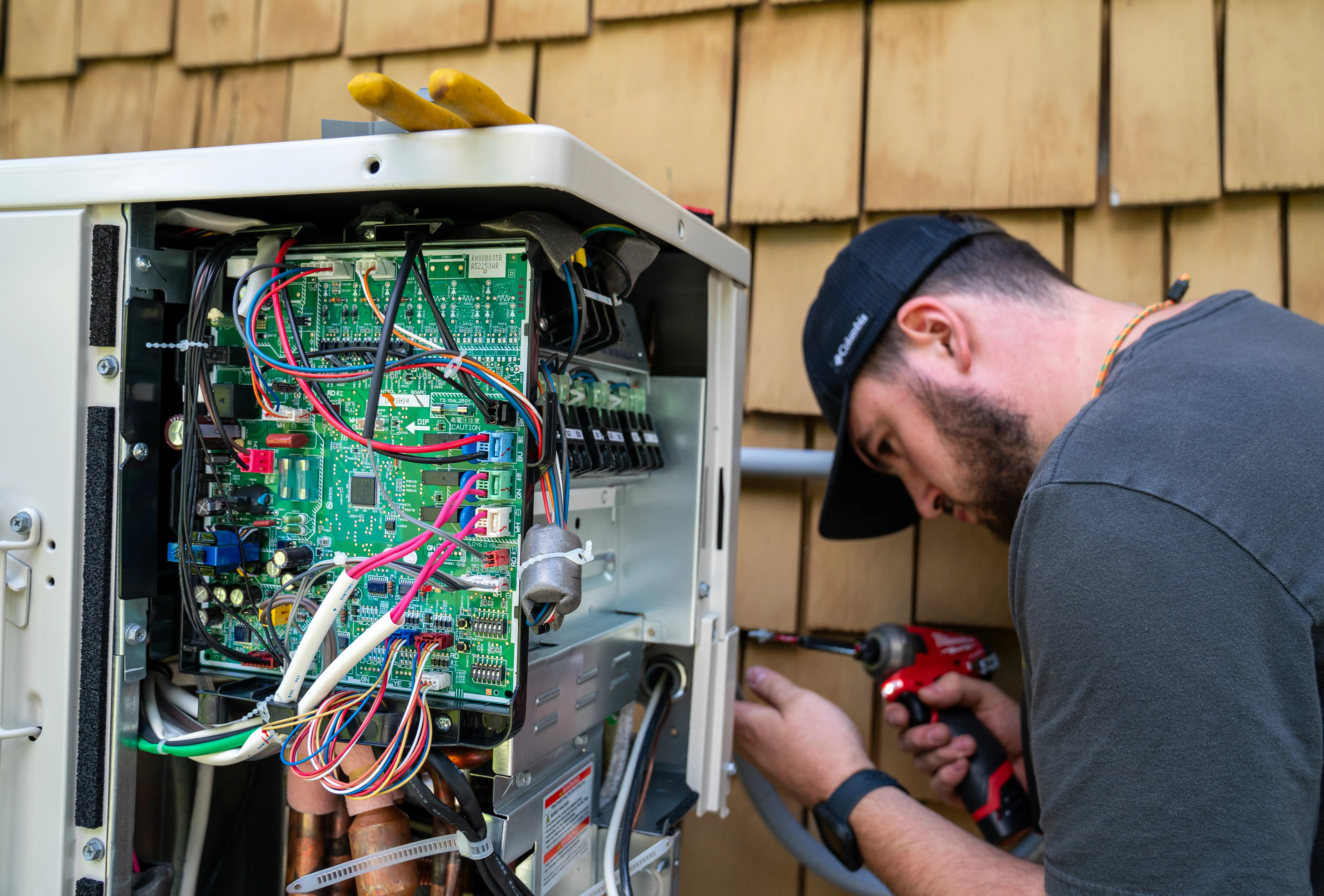 An electrician working on an HVAC system