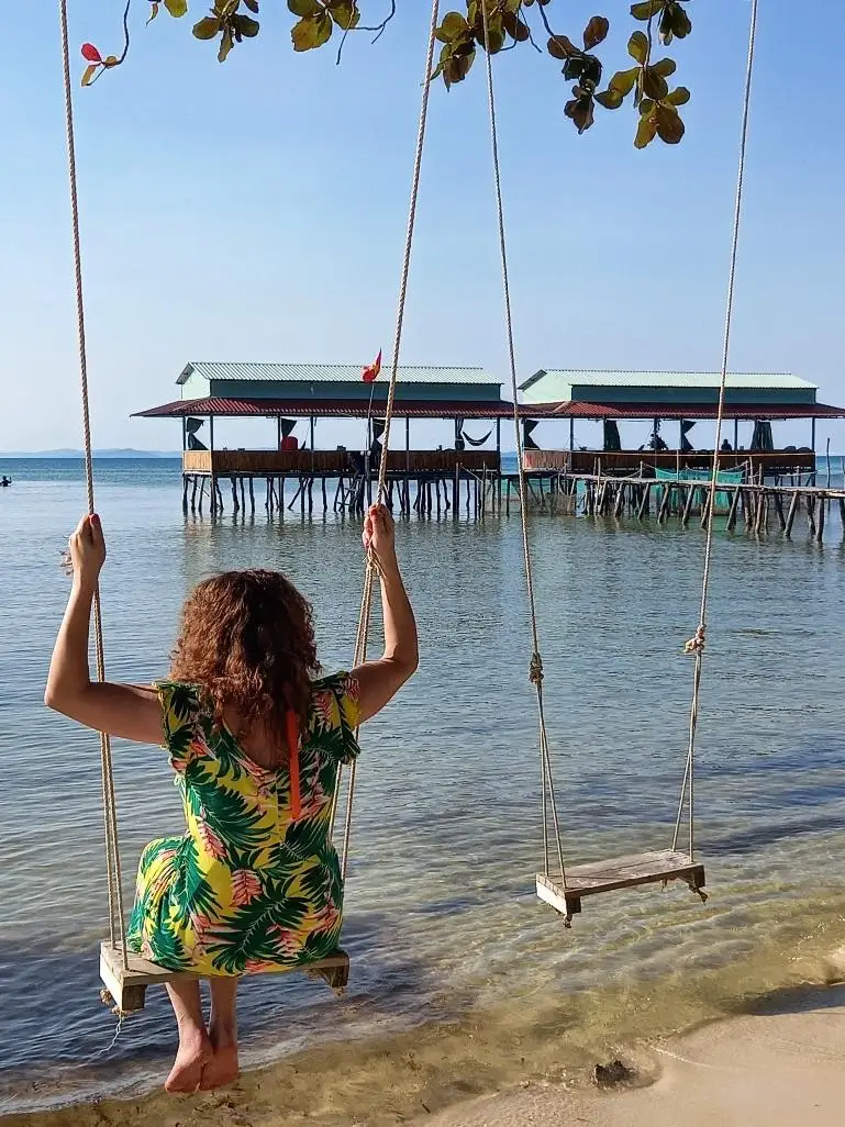 Woman on a swing at starfish beach on Phu Quoc island.