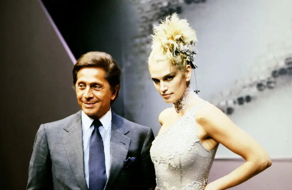 Cindy Crawford and designer Valentino Garavani walk the runway at the finale of the Valentino Fall 1997 Couture Runway Show.