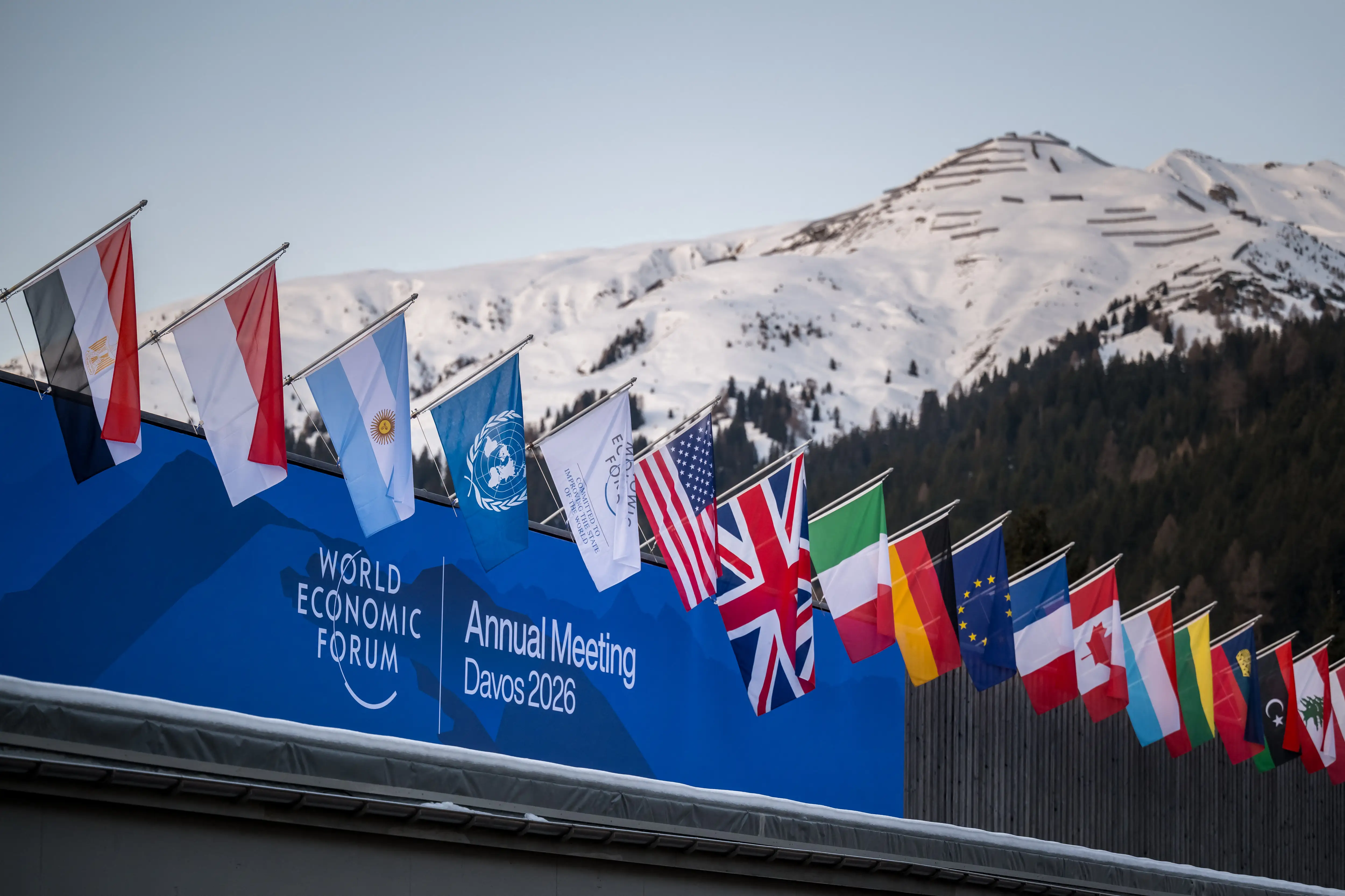 A sign of the World Economic Forum (WEF) is seen on the top of the Congress Centre that hosts the WEF annual meeting in the Alpine resort of Davos on its opening day in Davos on January 19, 2026.