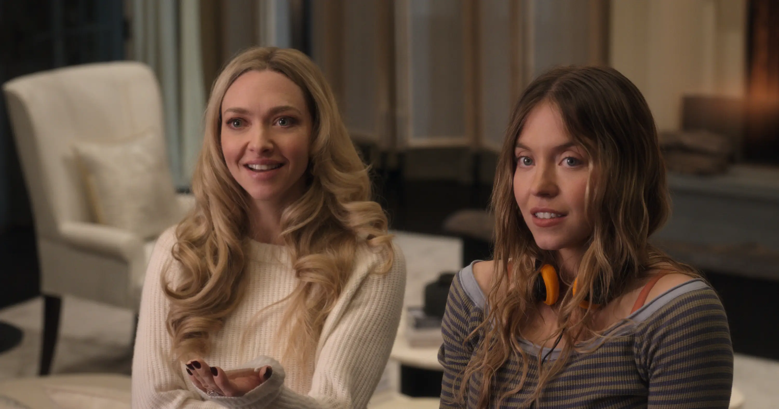 Amanda Seyfried and Sydney Sweeney smiling in The Housemaid