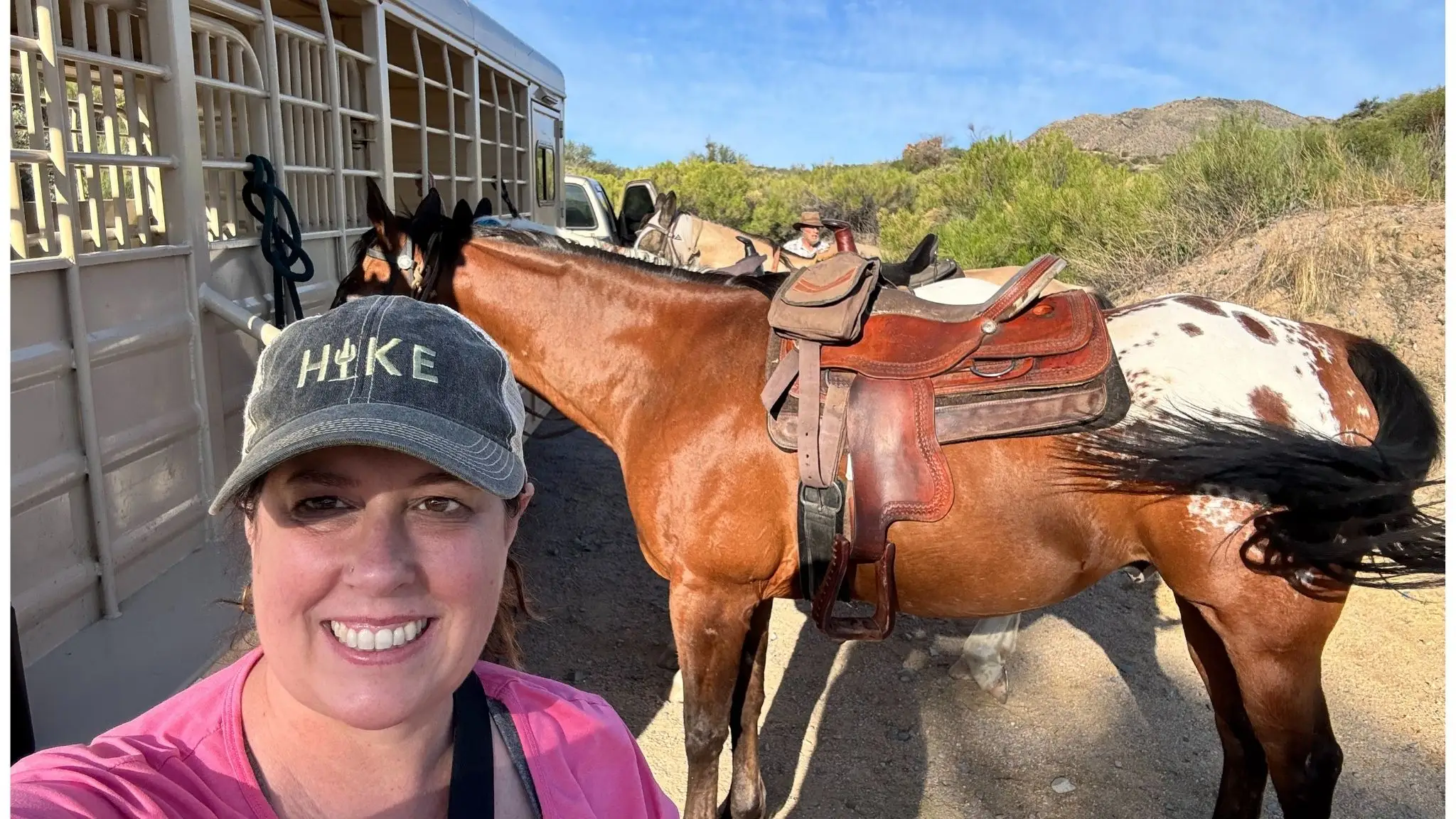 Author Chantelle Kincy smiling next to a horse
