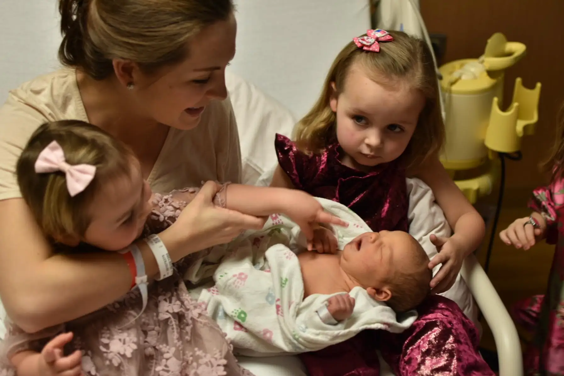 The writer holding her newborn baby, with two of her children nearby.