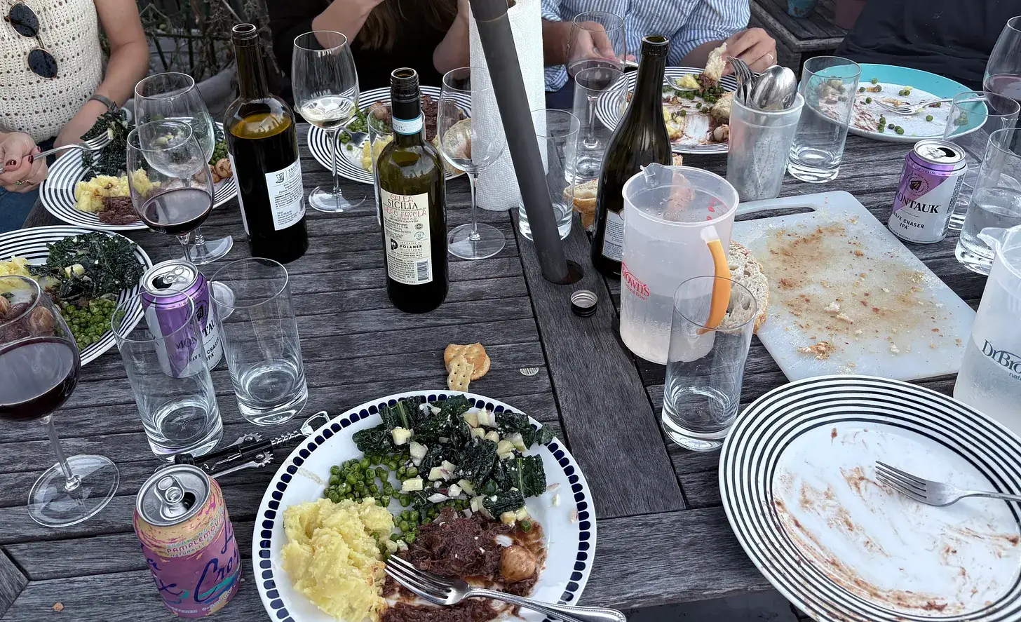 A dinner table covered in plates and glasses.