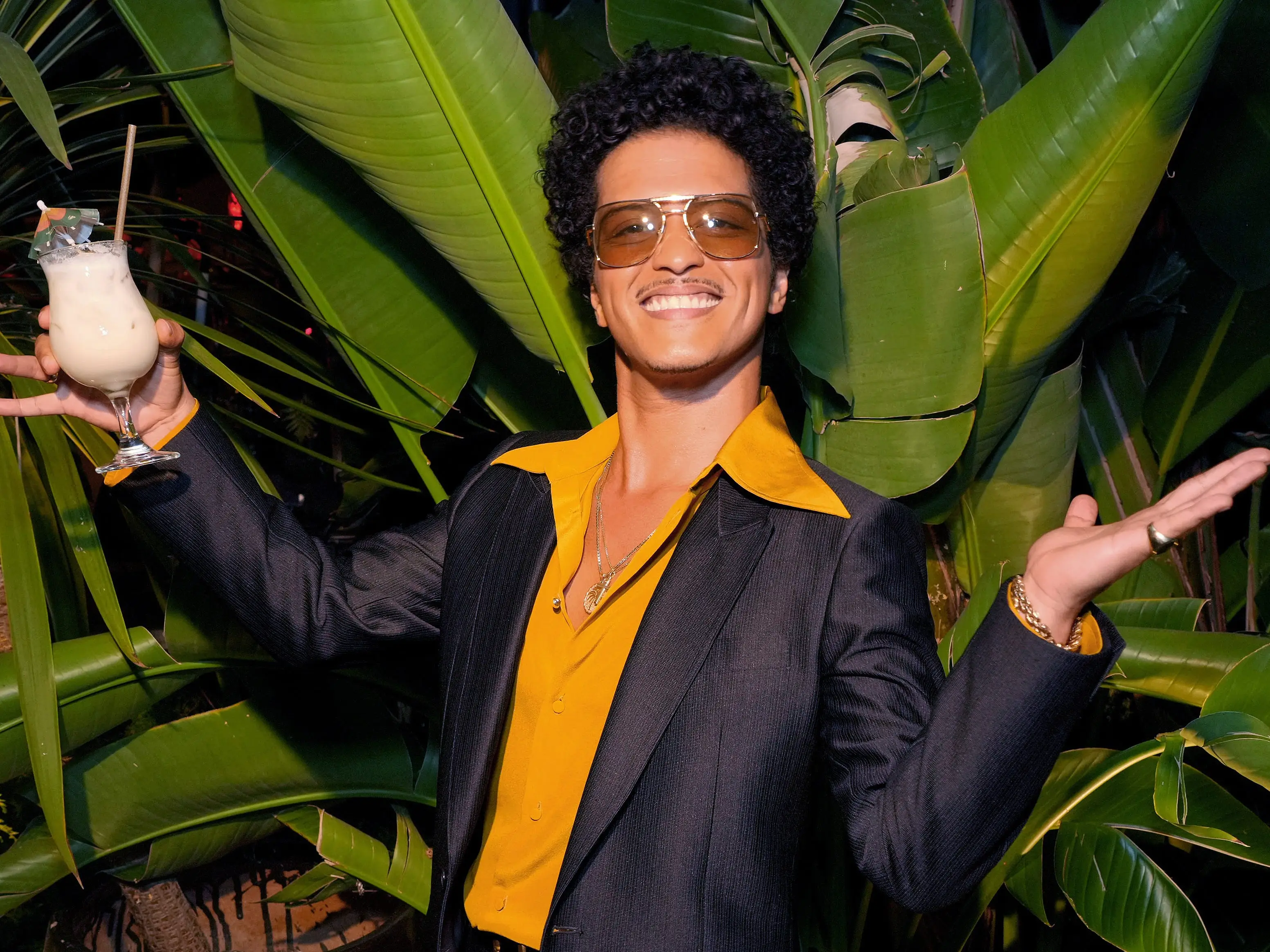 Bruno Mars holding a drink