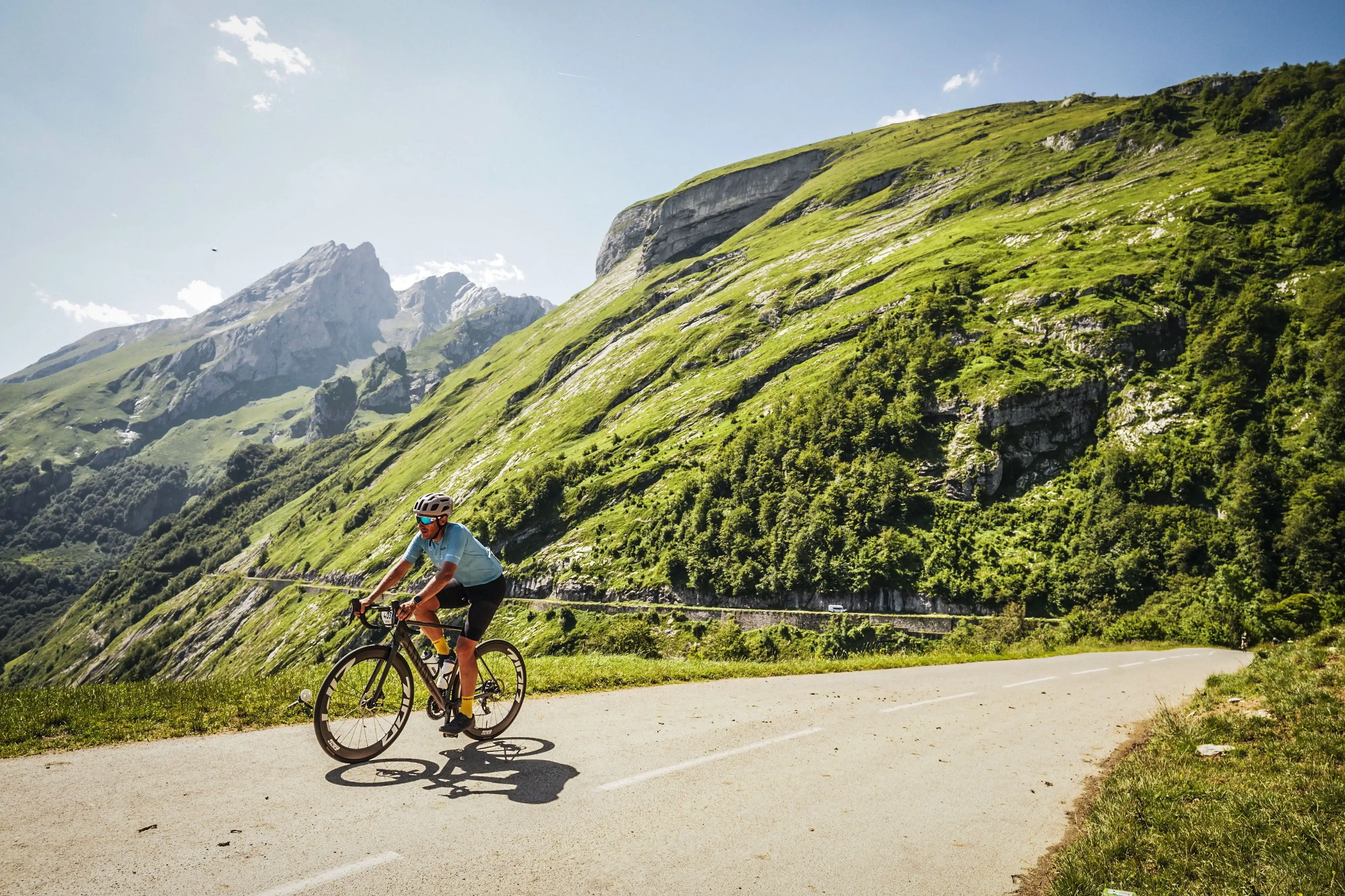 A cyclist travels down a scenic road.