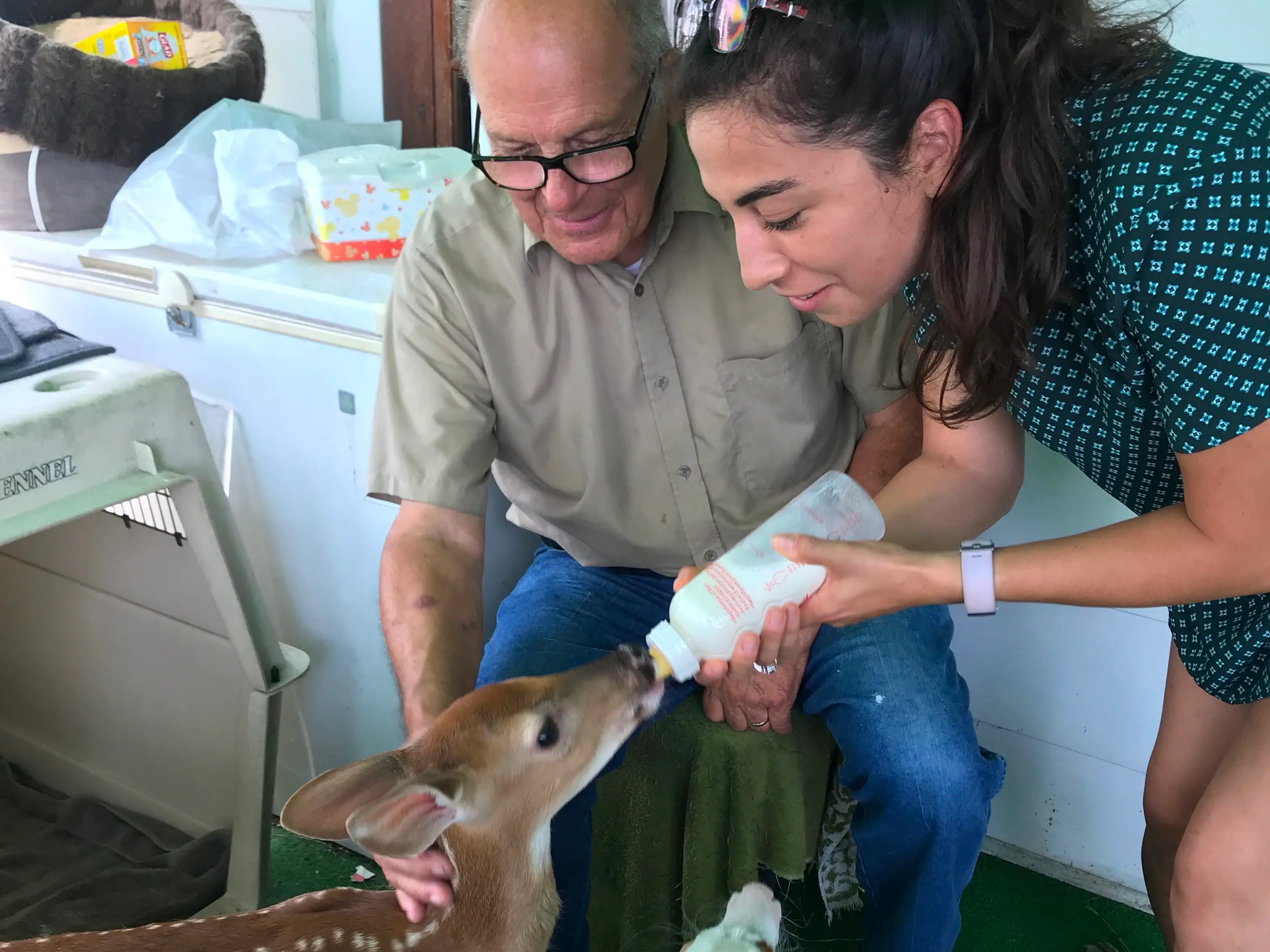 the author and her grandfather feeding deer milk