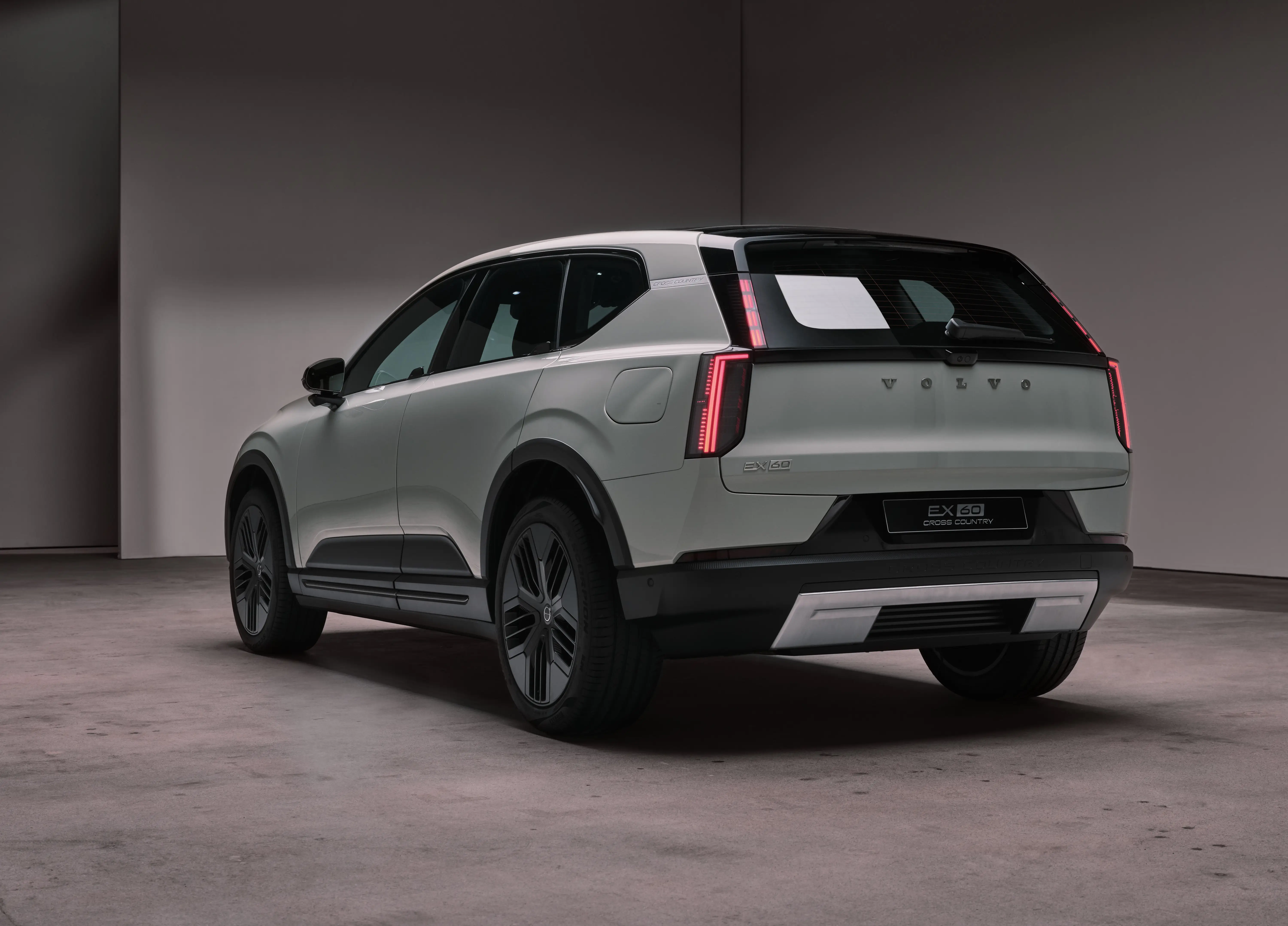 A gray EX60's rear. The car features stacked taillights, like other classic Volvo designs, and a silver skid plate for off-roading.