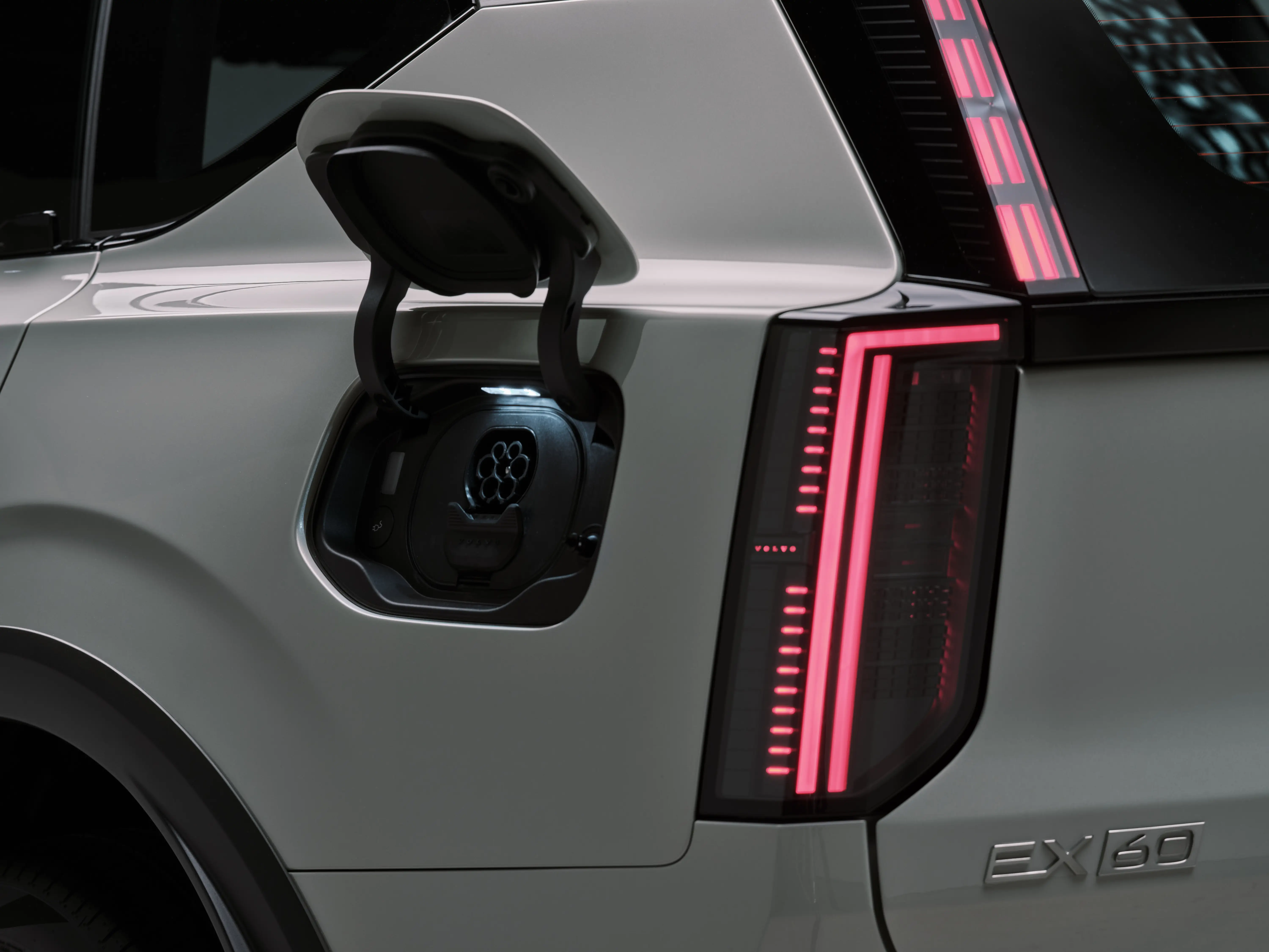 The charging port, located on the driver's side rear panel, is opened. It's revealing a circular charging port, which can plug into Tesla's Supercharger network.
