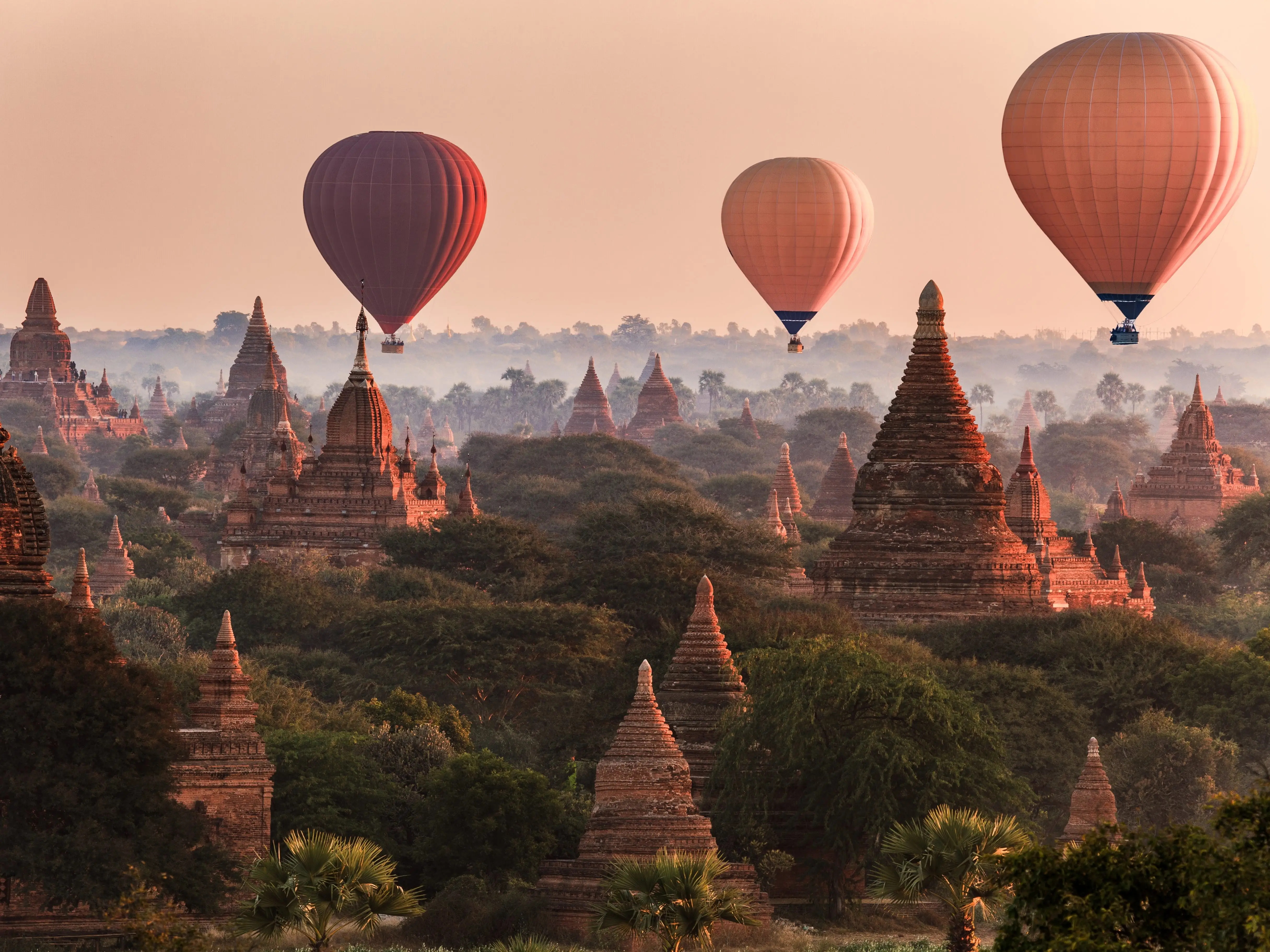 Hot air balloon over plain of Bagan in misty morning, Myanmar