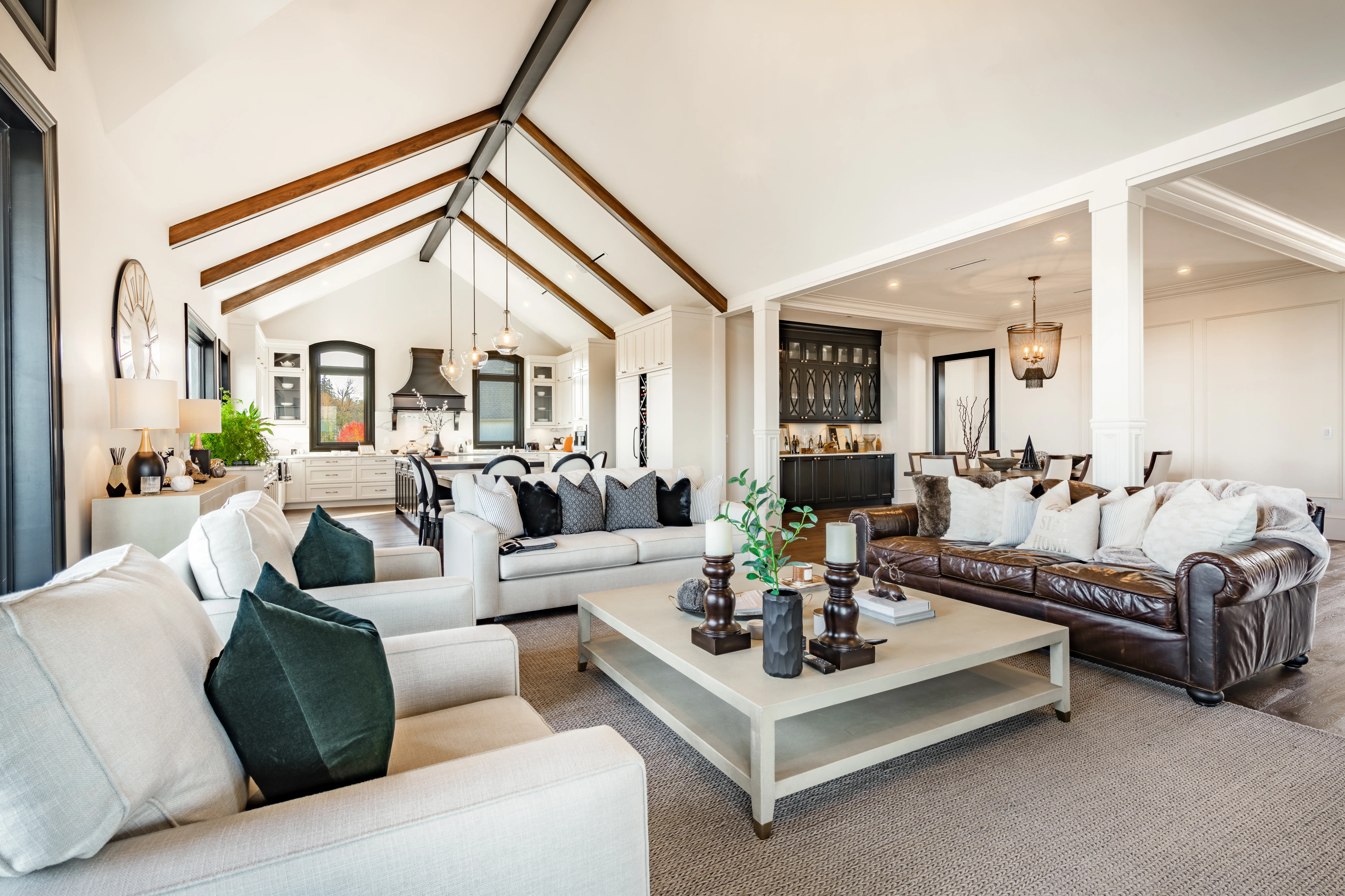 Living room with vaulted ceilings, leather couch, large coffee table