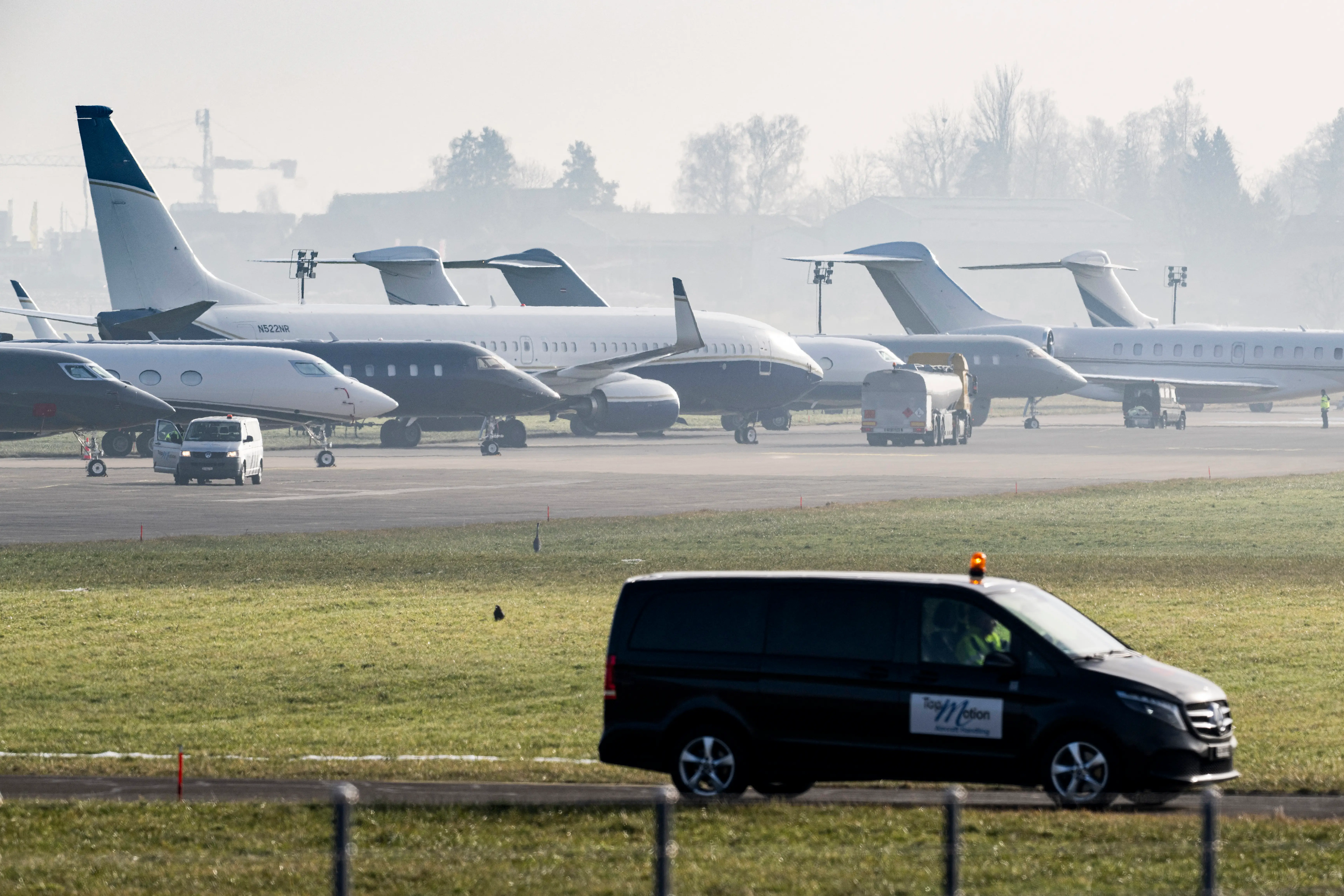 Private and VIP aircraft belonging to participants of the World Economic Forum (WEF) in Davos are parked behind privacy barriers at Zurich Duebendorf Airport on January 20, 2026.