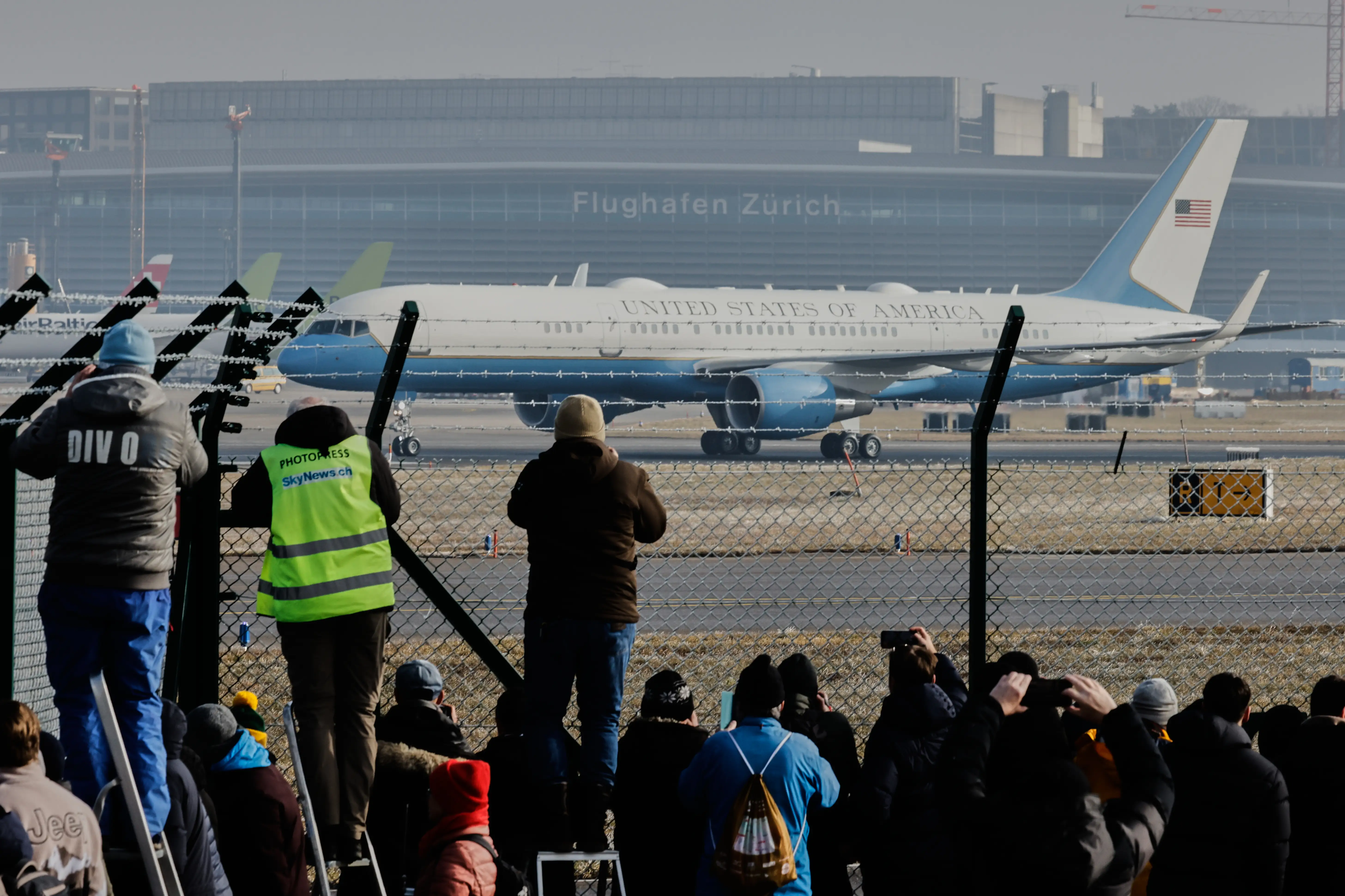 People take photos of Air Force One landing at the airport in Zurich, Switzerland, Wednesday, Jan. 21, 2026.
