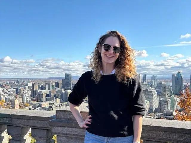 The writer posing with Montreal buildings in the background.