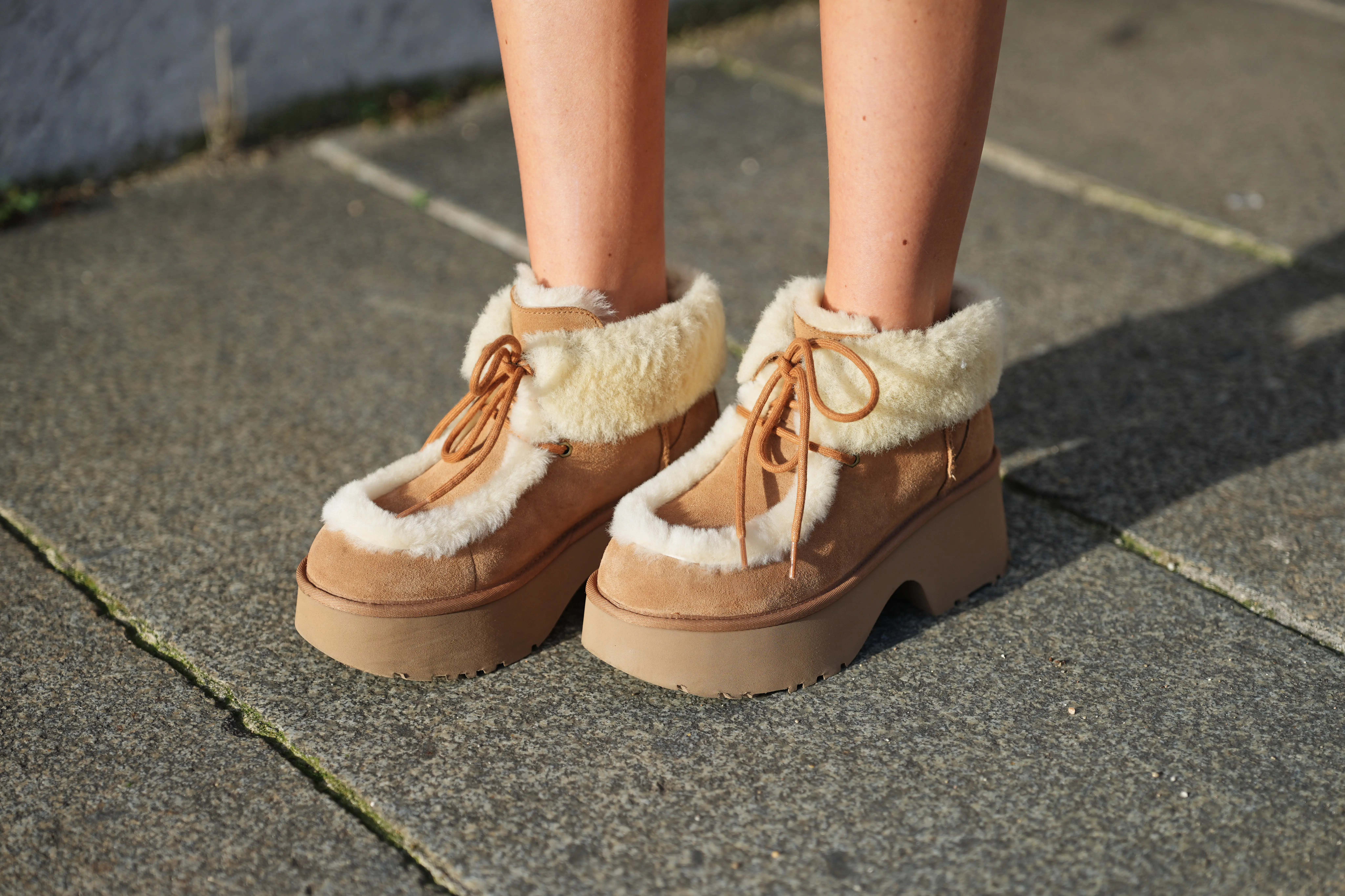 PLatform boots with laces and shearling accents on feet