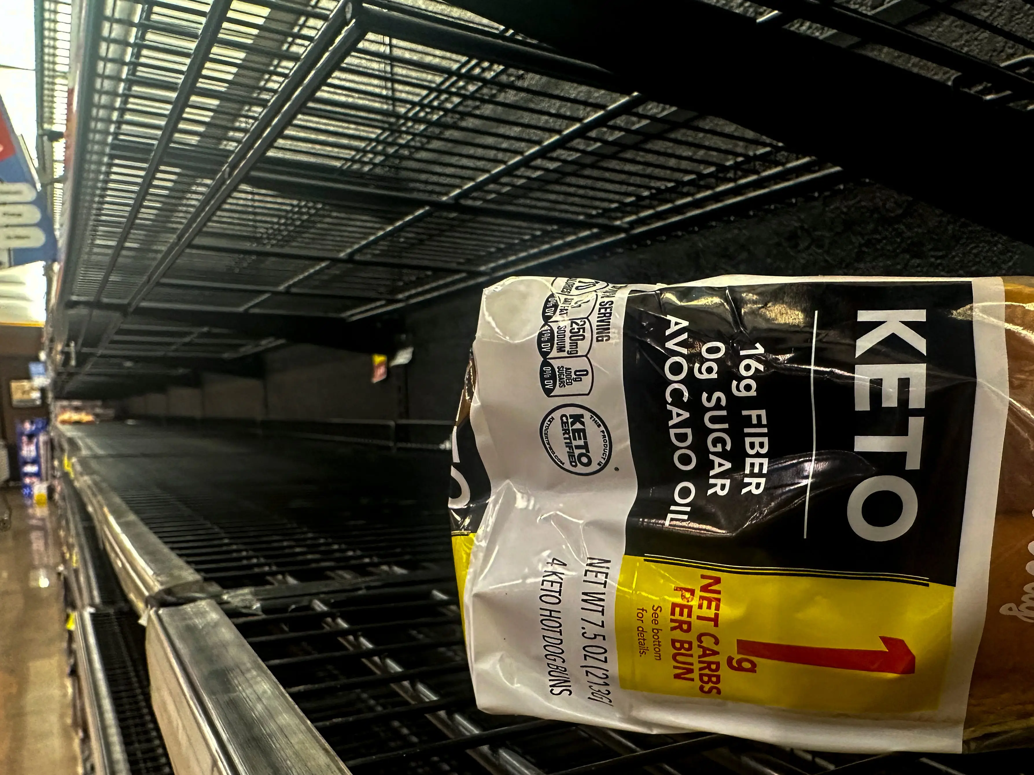 A loaf of bread sits on empty shelves in the bread isle in grocery store ahead of winter weather, Wednesday, Jan. 21, 2026, in Marietta, Ga