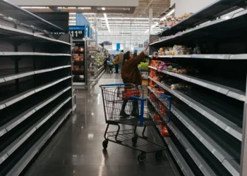 Photos show empty supermarket shelves as millions across the US brace for Winter Storm Fern