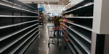 Photos show empty supermarket shelves as millions across the US brace for Winter Storm Fern