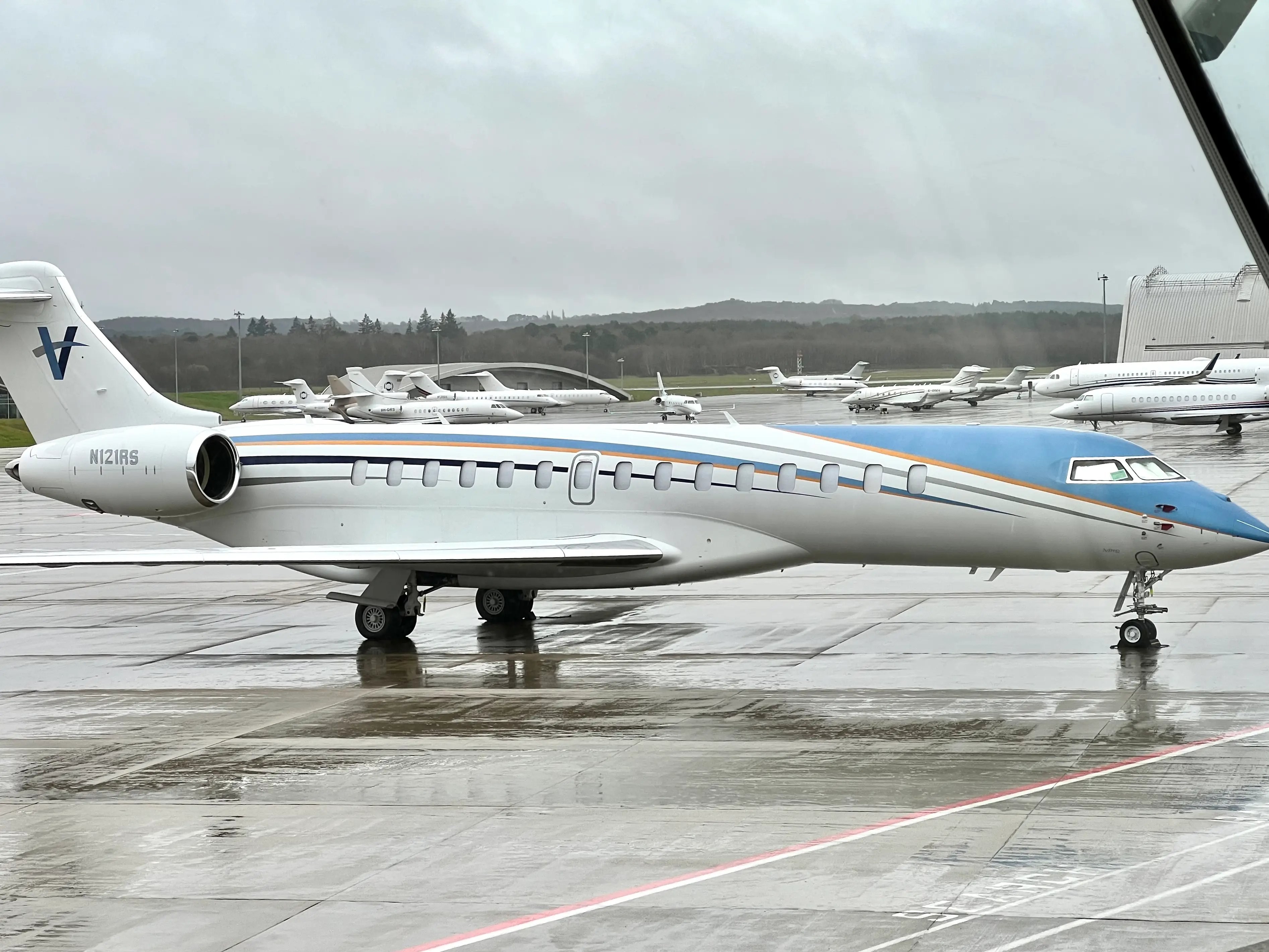 A Bombardier Global 7500 private jet pictured on a rainy day at Farnborough Airport in March 2024