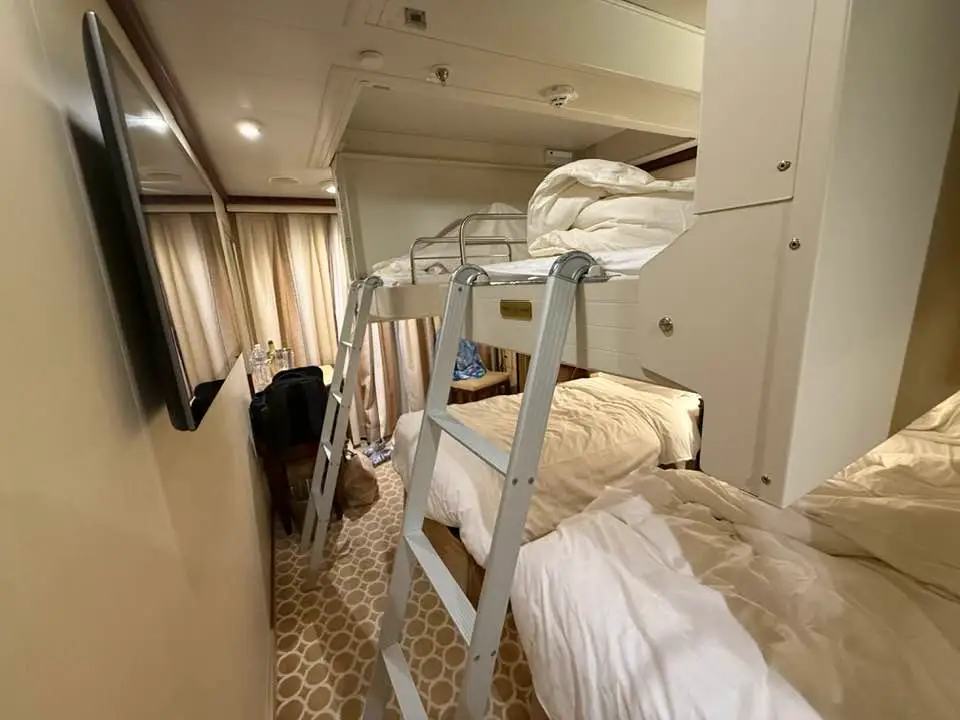 Beds from ceiling with ladders leading up to them