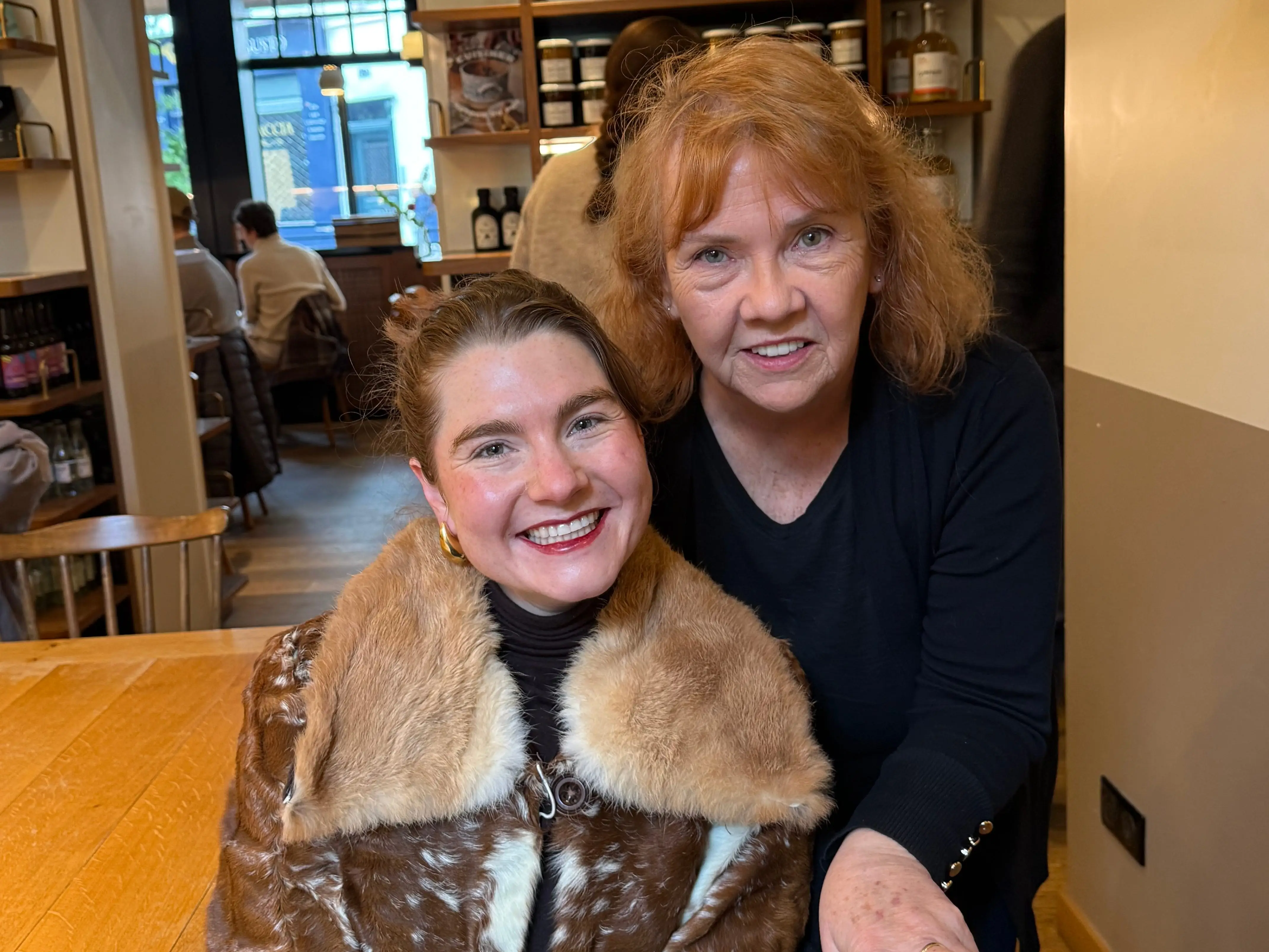 Sandy Adam and a young woman are smiling.