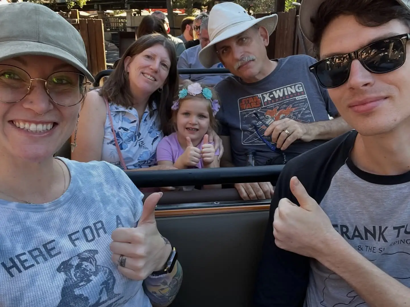 Family on ride giving thumbs up