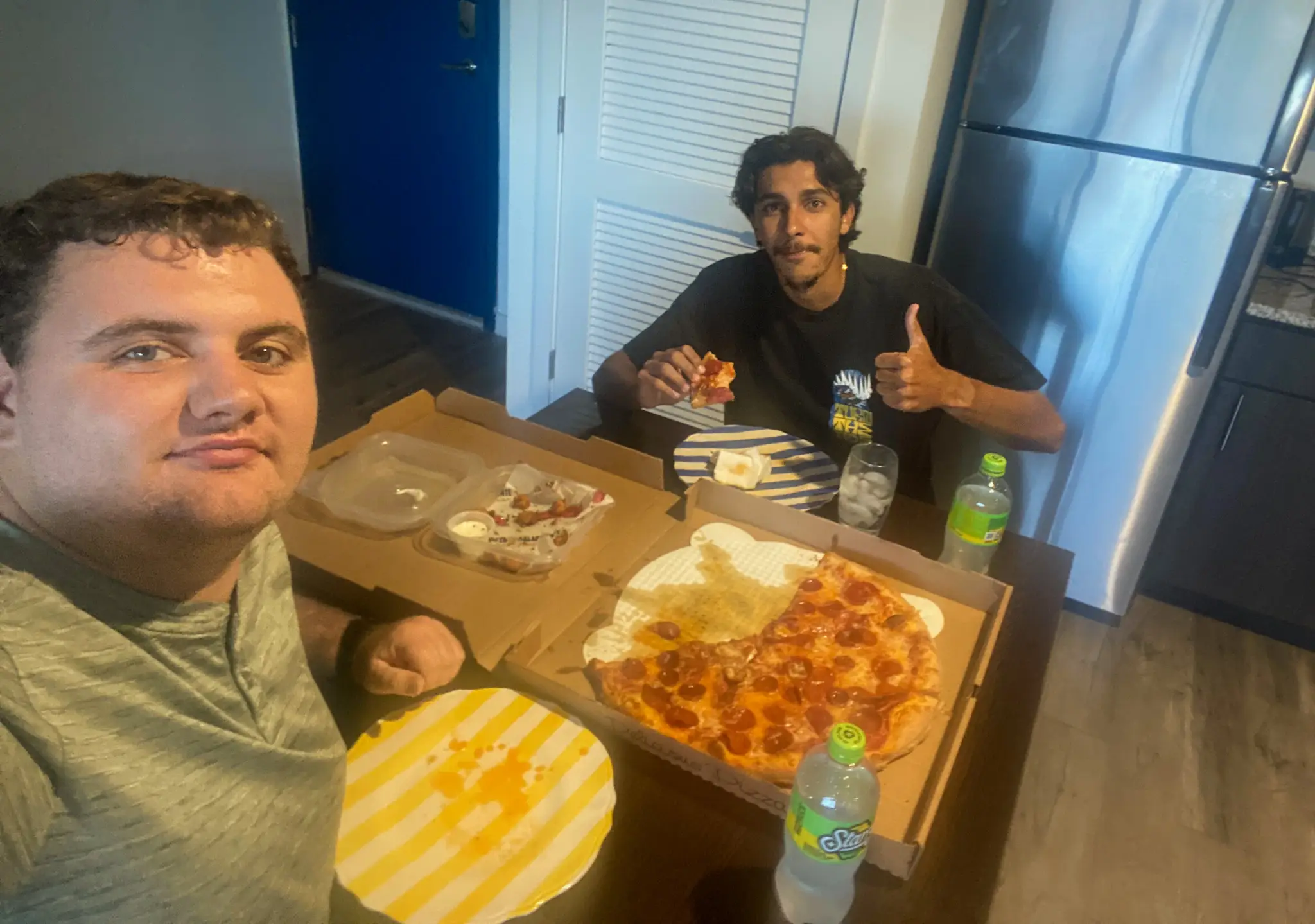 Cristine Struble's son eating pizza with a friend