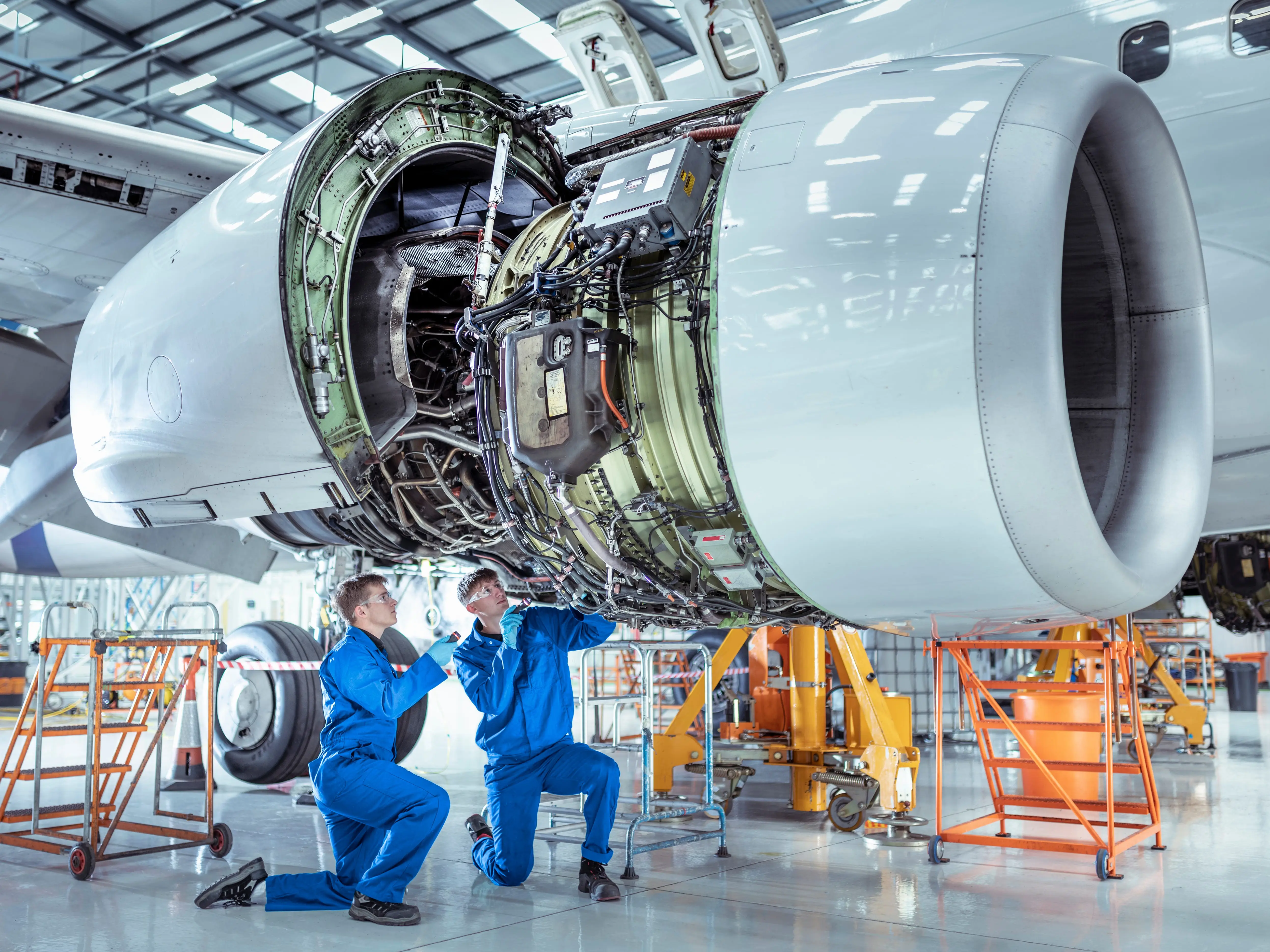 Two people doing aircraft maintenance