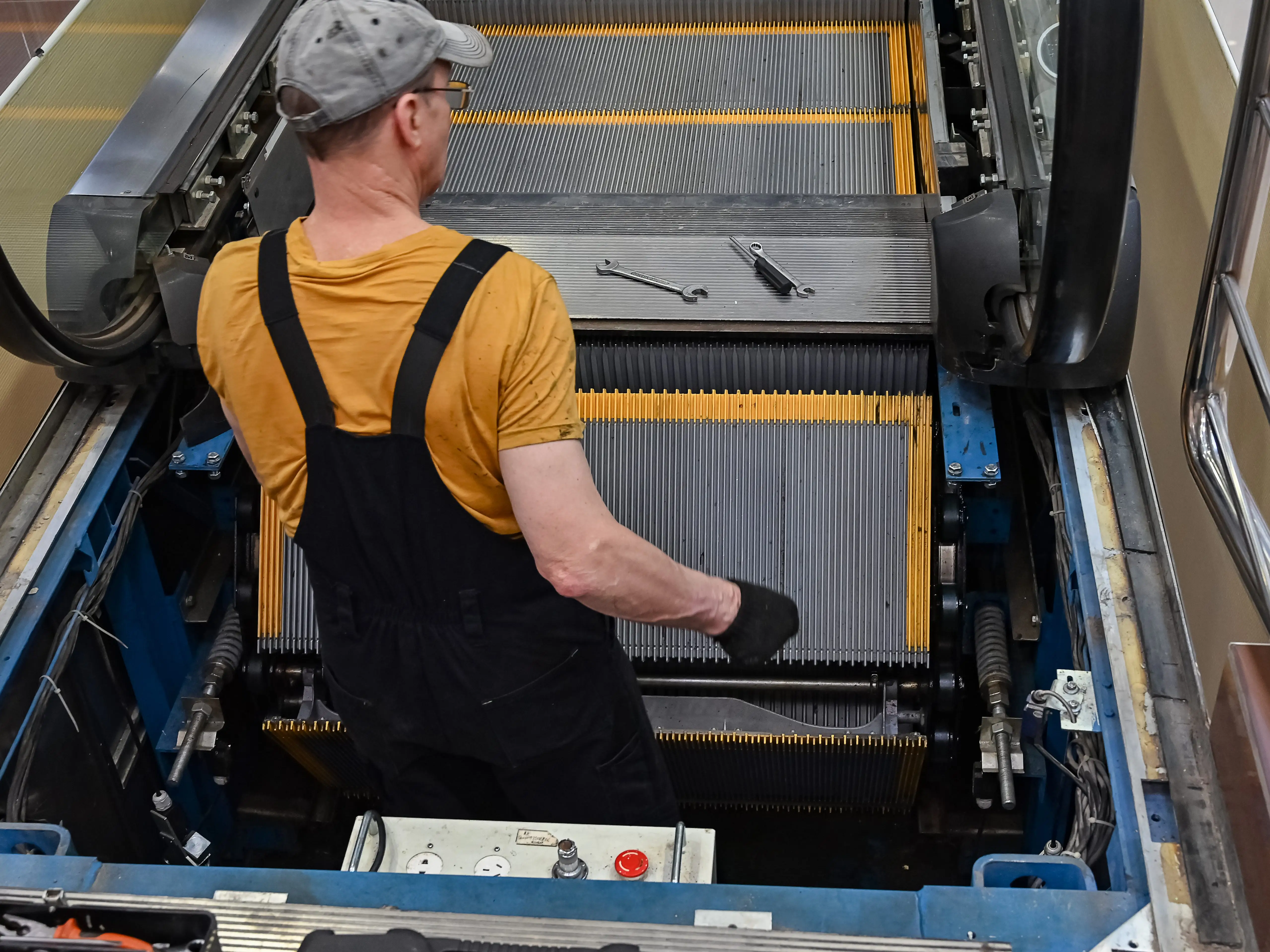 Worker repairing escalator