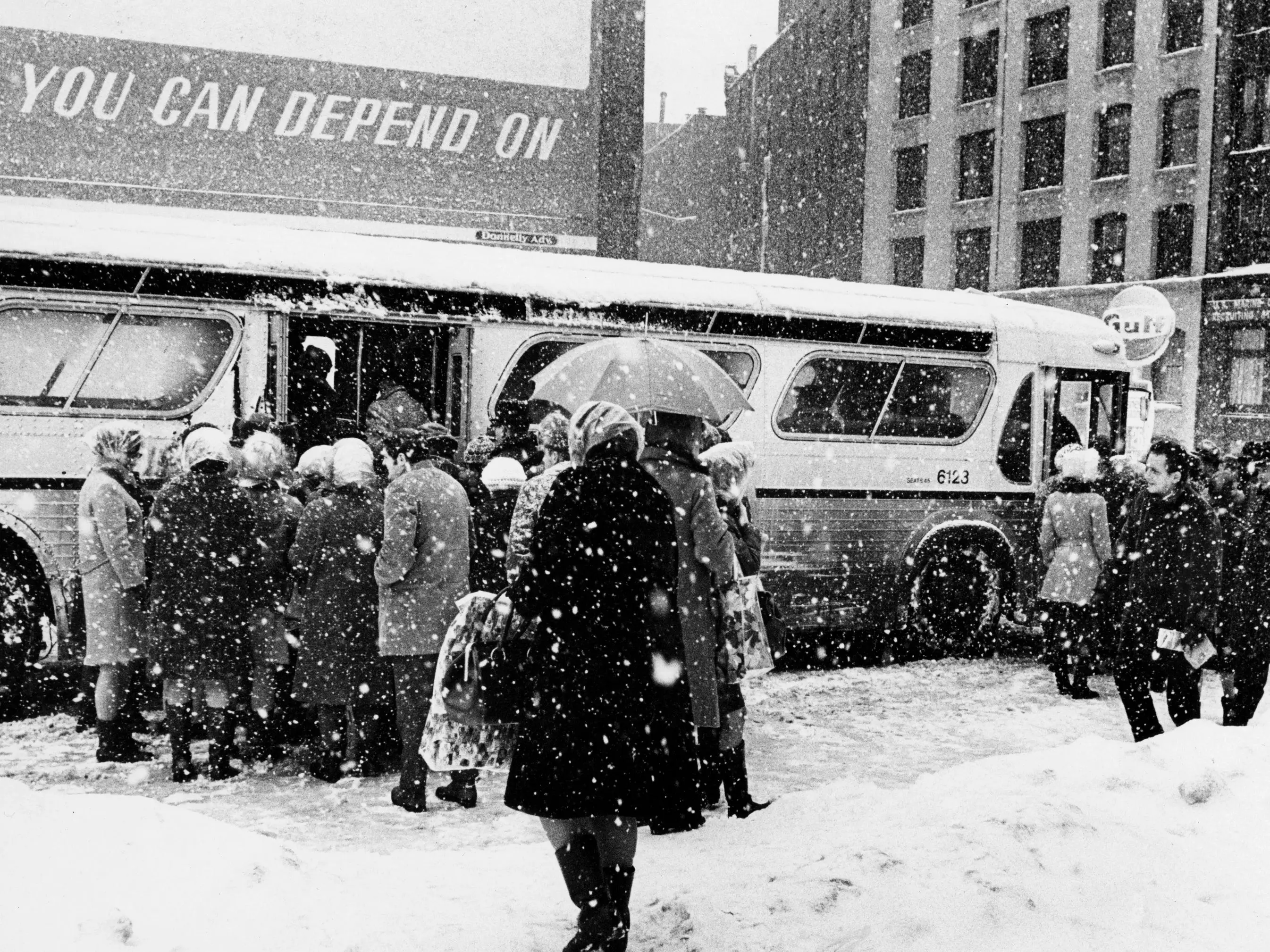 A crowd boards a bus in the snow on Summer Street in Boston on March 3, 1969, after the third major snow storm of the year. The four-day storm, between Feb. 24 and 28, left 26.3 inches of snow in the city.