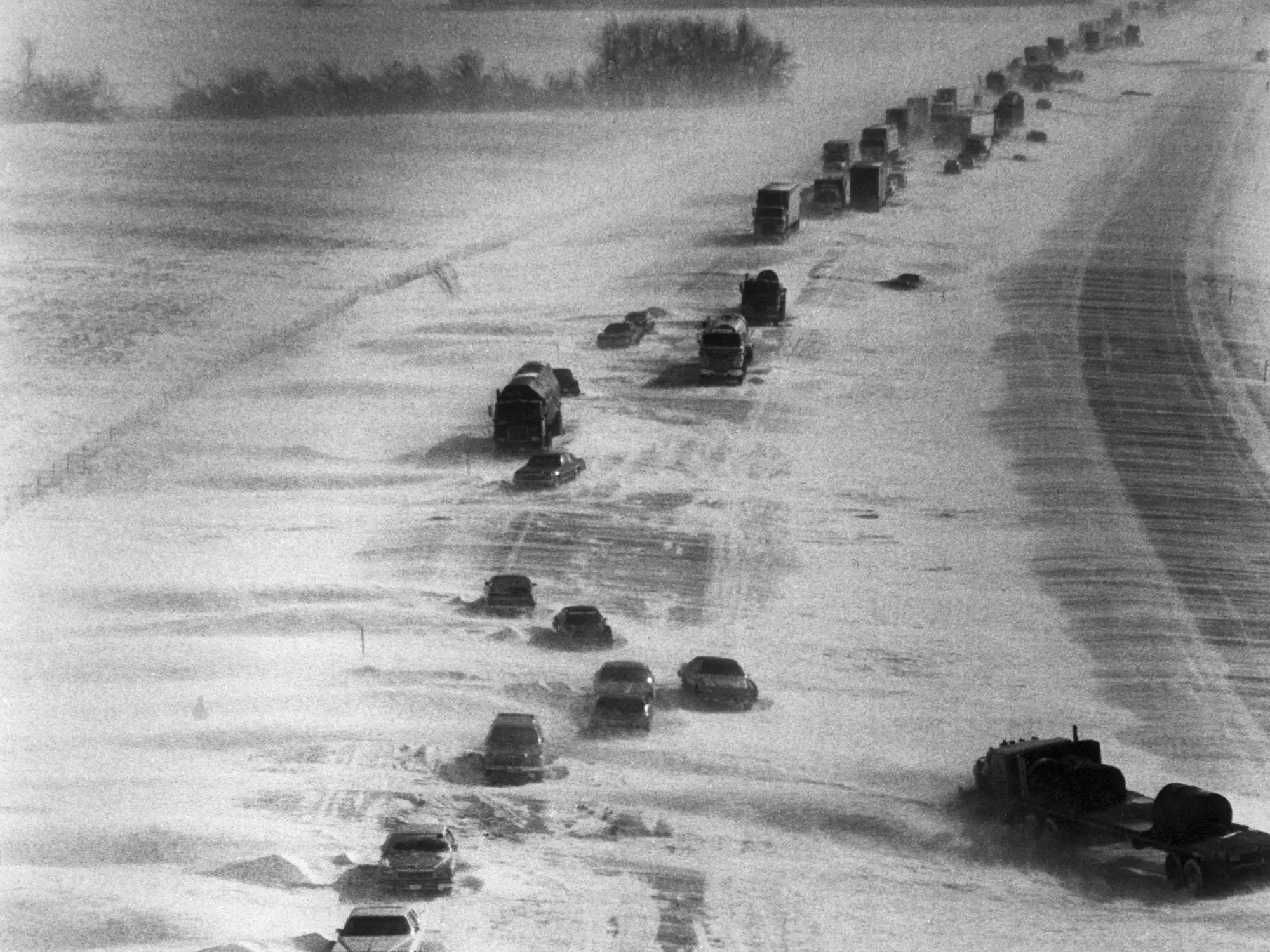 1/29/1977-Lafayette, IN- As far as the eye can see, abandoned vehicles line snowbound I-65 near Lafayette in Central Indiana. Hundreds of truckers and motorists hav taken refuge in nearby towns waiting a break in the bitter sub-zero cold to resume their travels.