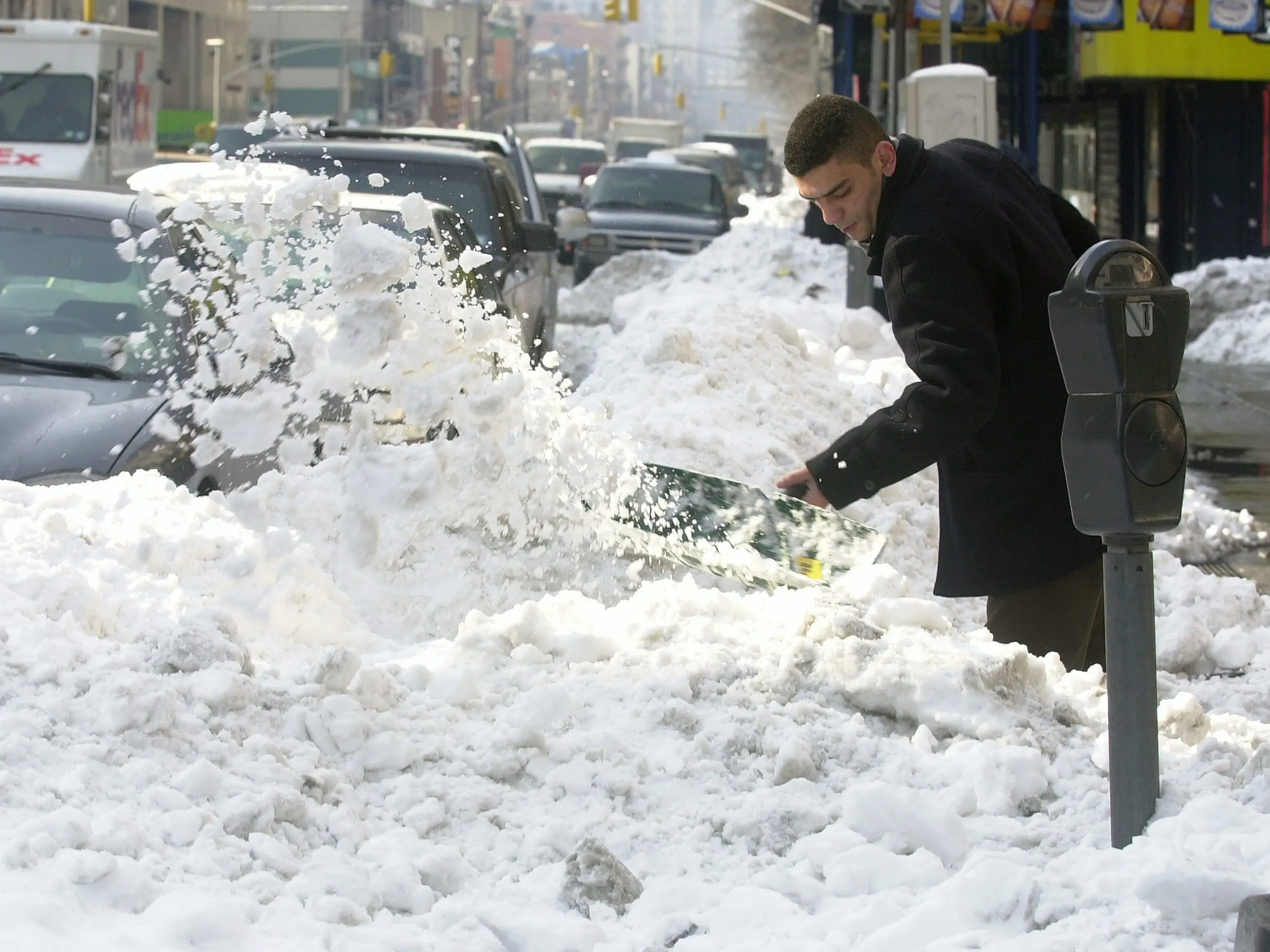 Snow removal goes on along Eighth Ave. two days after the Presidents' Day blizzard covered the city with a heavy white blanket.