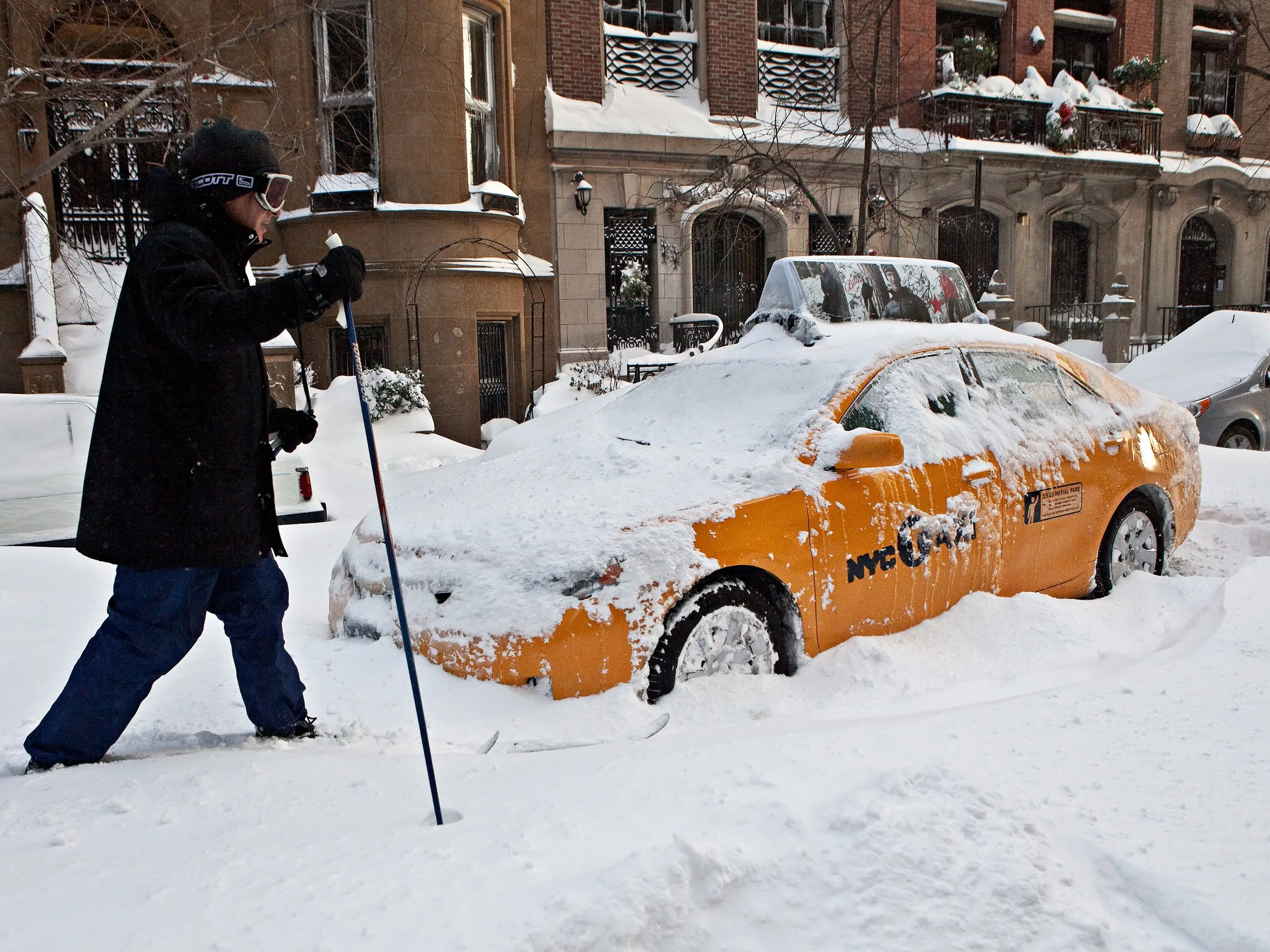 David Karnovsky, general counsel for the New York City Department of City Planning, cross country skis around an abandoned taxi on West 73rd Street on December 27, 2010 in New York City. A blizzard pounded the East Coast of the United States delivering 20 inches of snow to New York City while snarling post-Christmas travel.