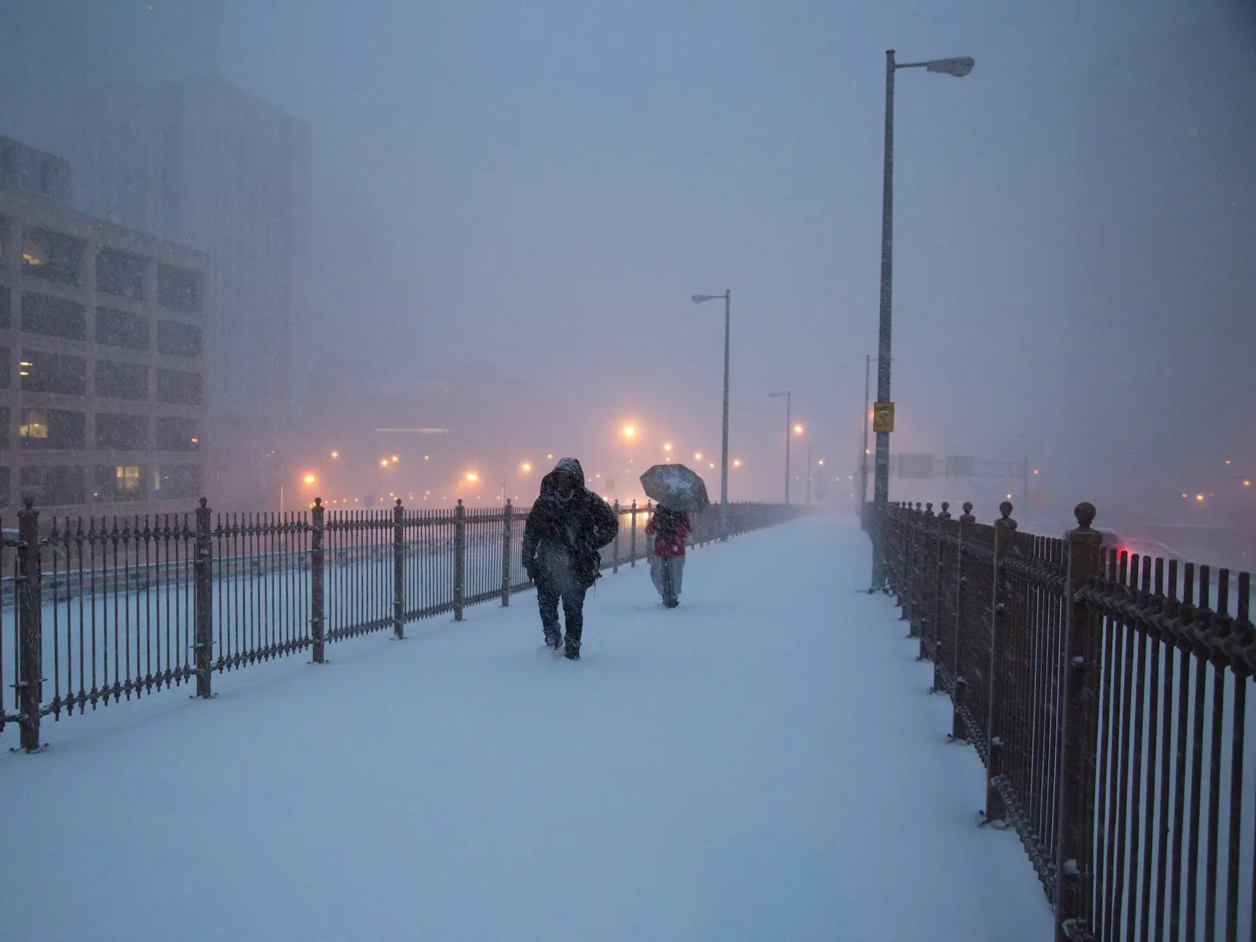 New Yorkers brave the Brooklyn Bridge. The first snow falls throughout the early morning as New York prepares for historic East Coast Blizzard.