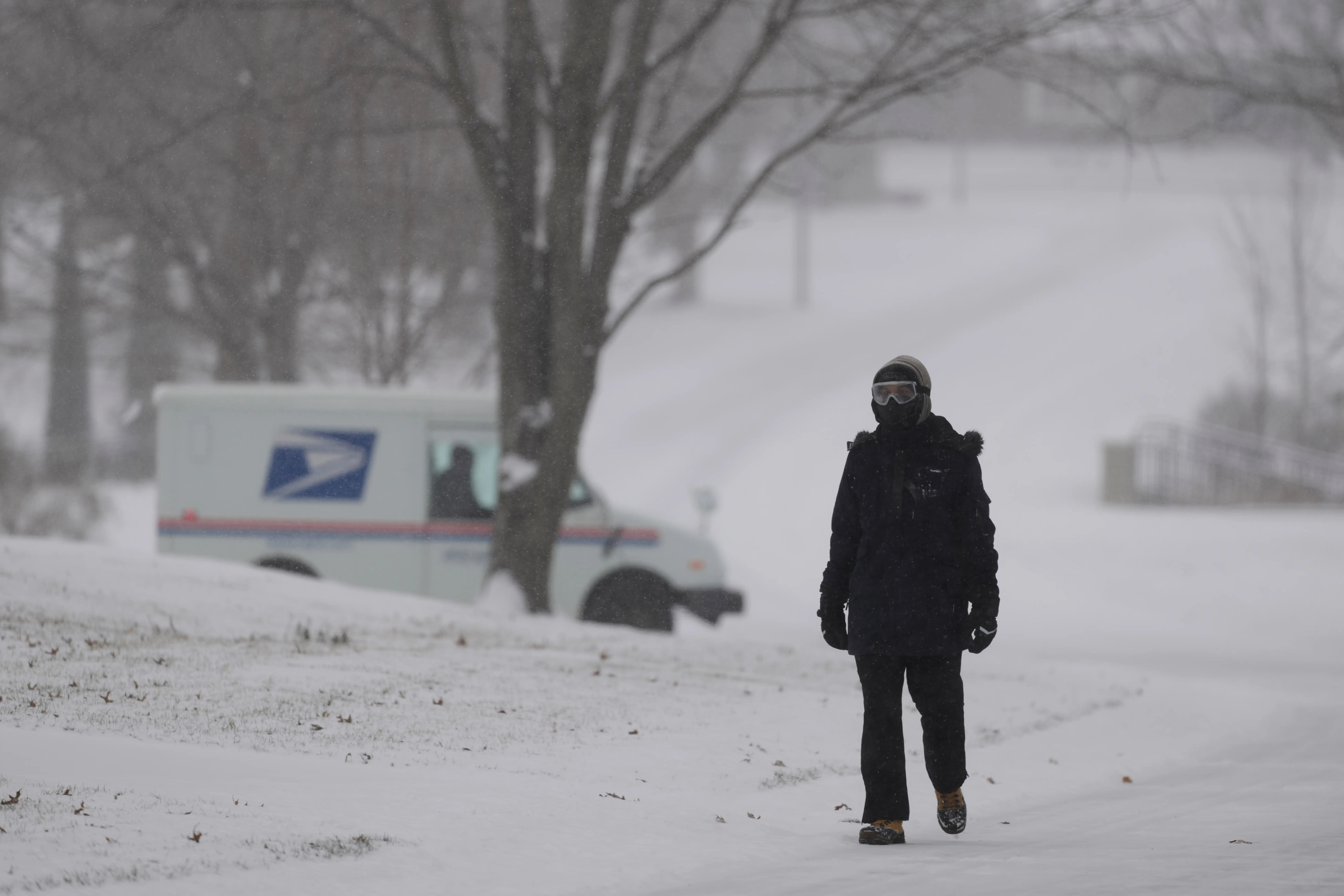 Man walks amid the 2026 winter storm Prairie Village, Kansas.