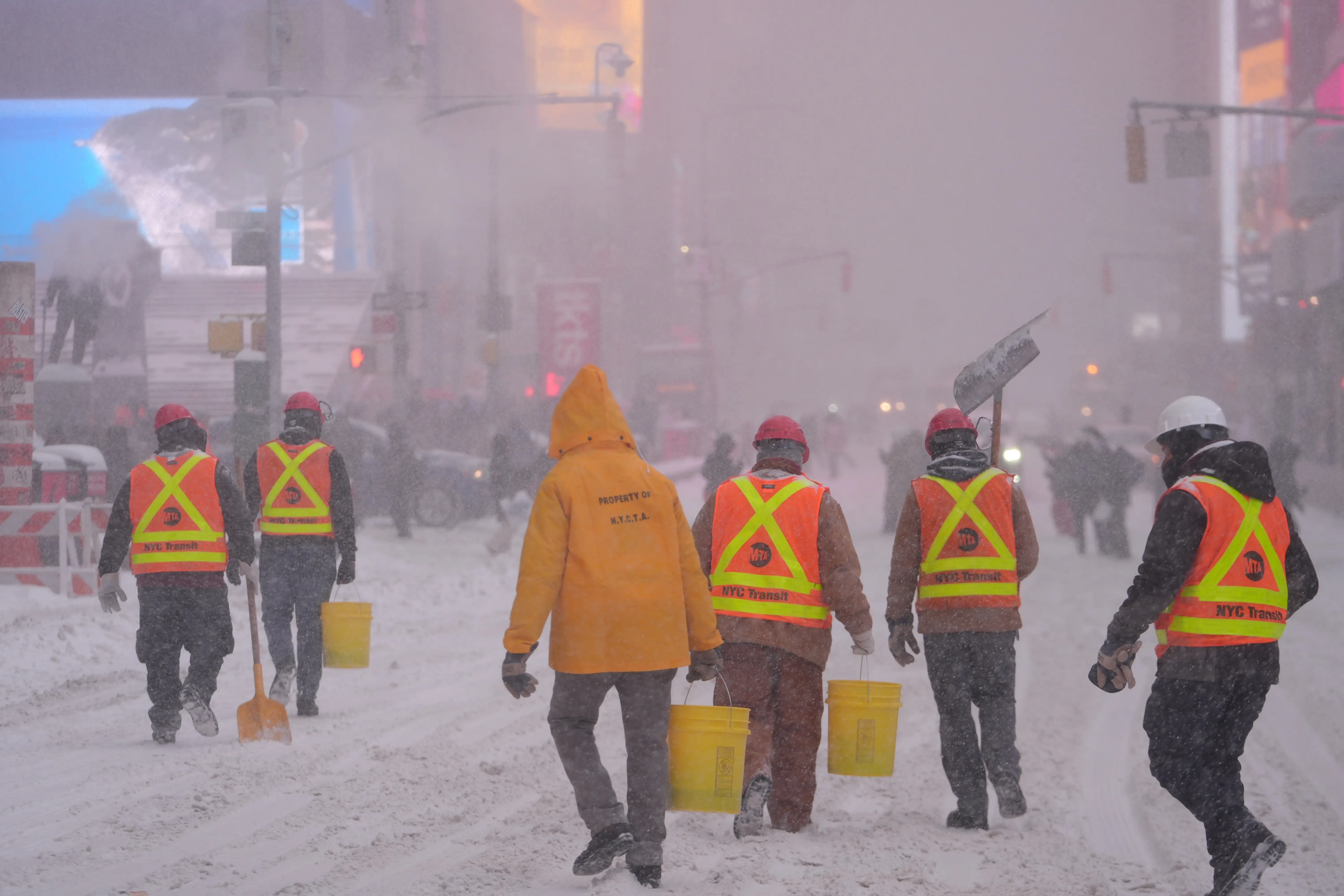 Workers clearing snow in New York City during winter storm.