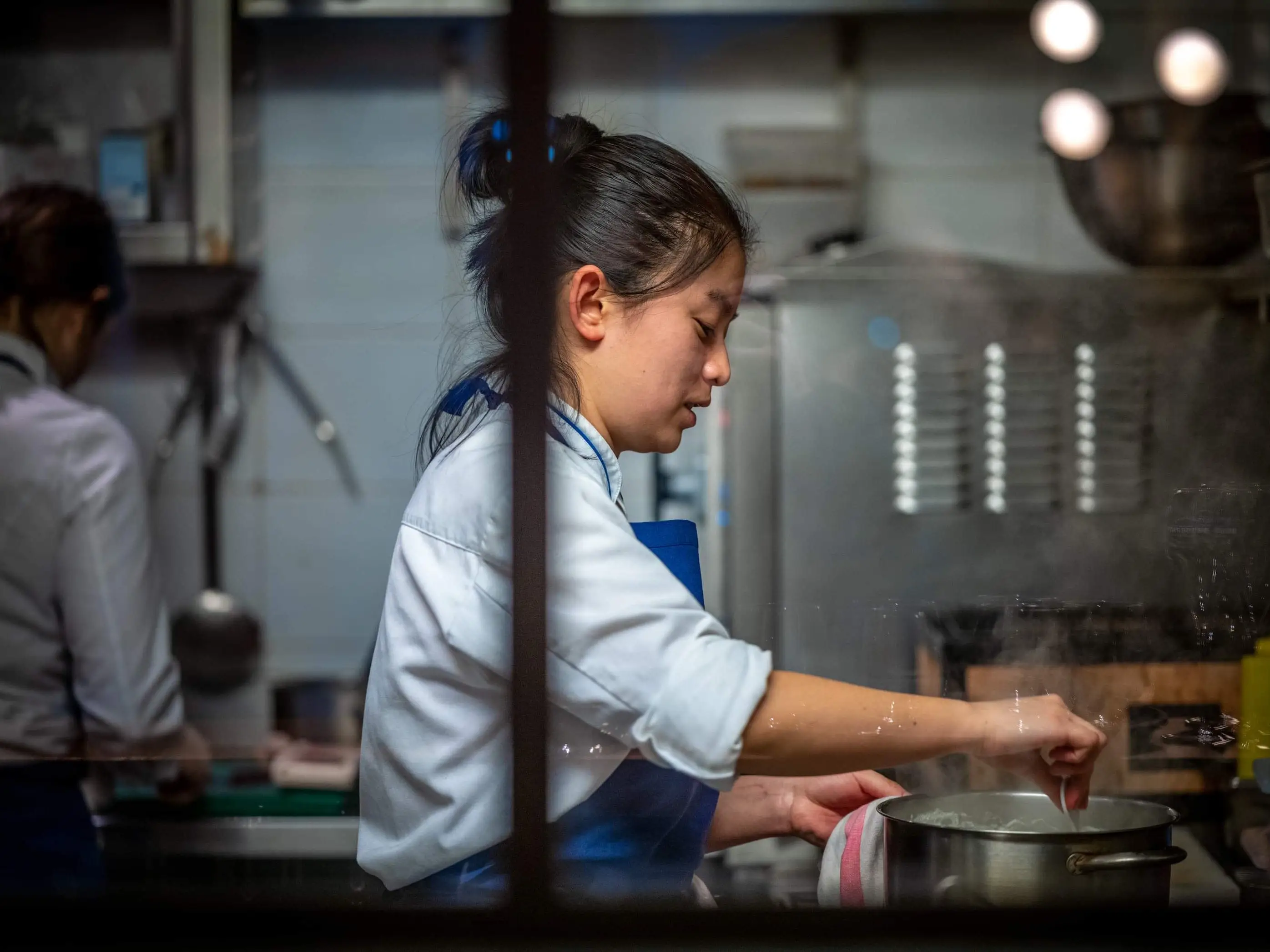 Vivienne Zhao working in a French restaurant in Paris.