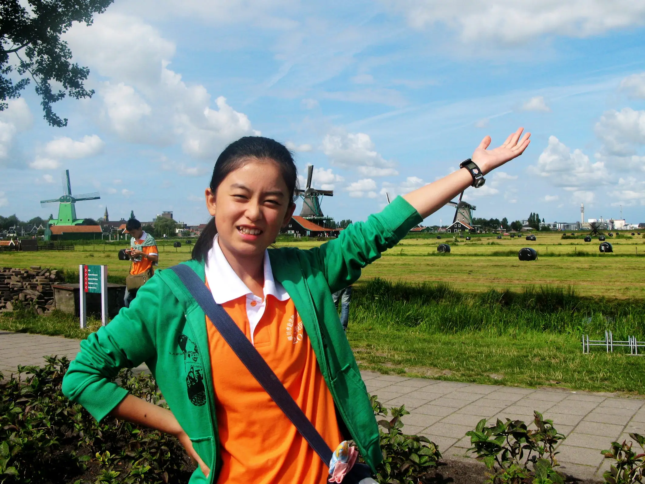 Vivienne Zhao in the French countryside when she was 14, posing with windmills in the background.